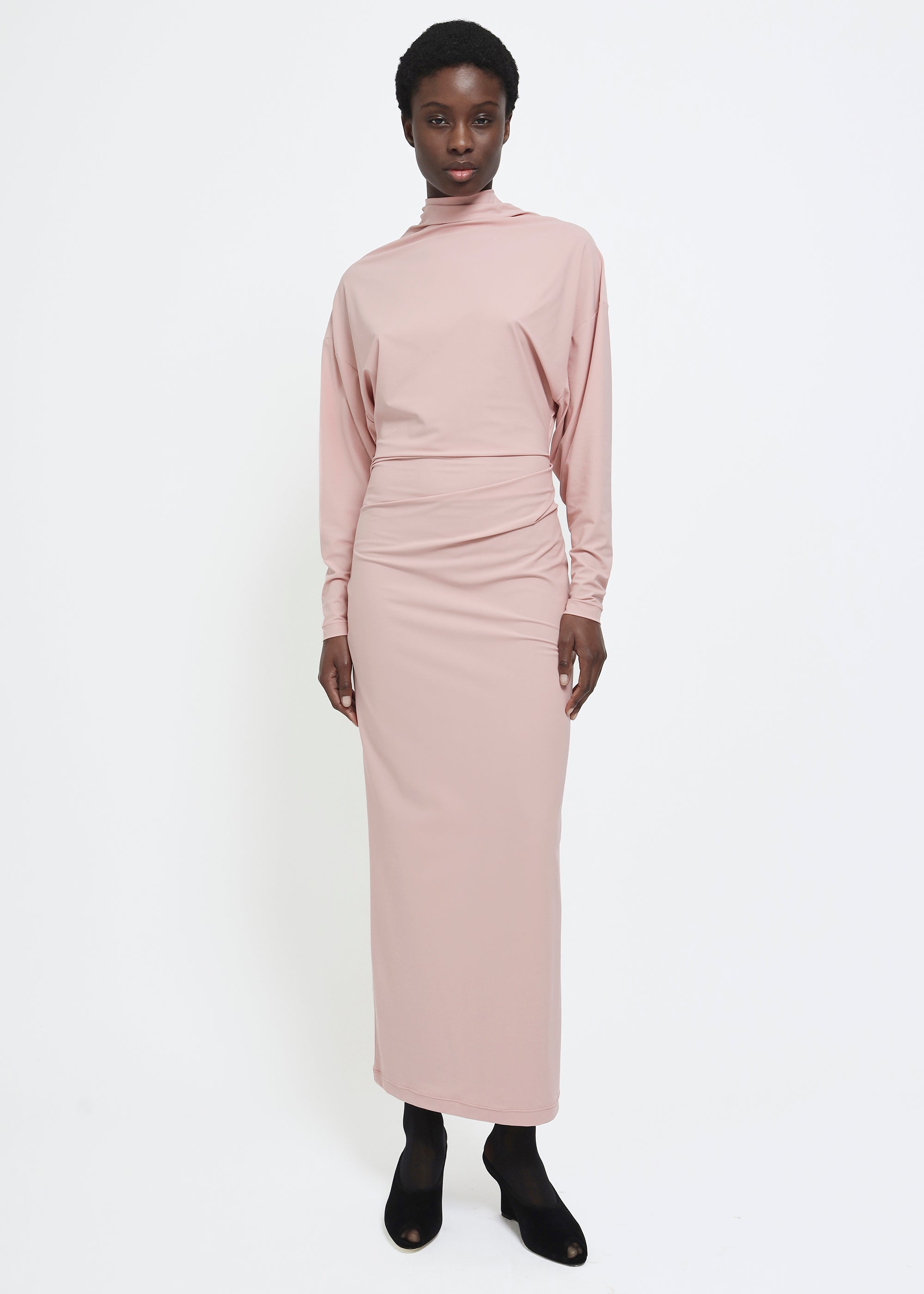 A dusty pink long-sleeve mock-neck midi dress with gathered detailing at the waist.
