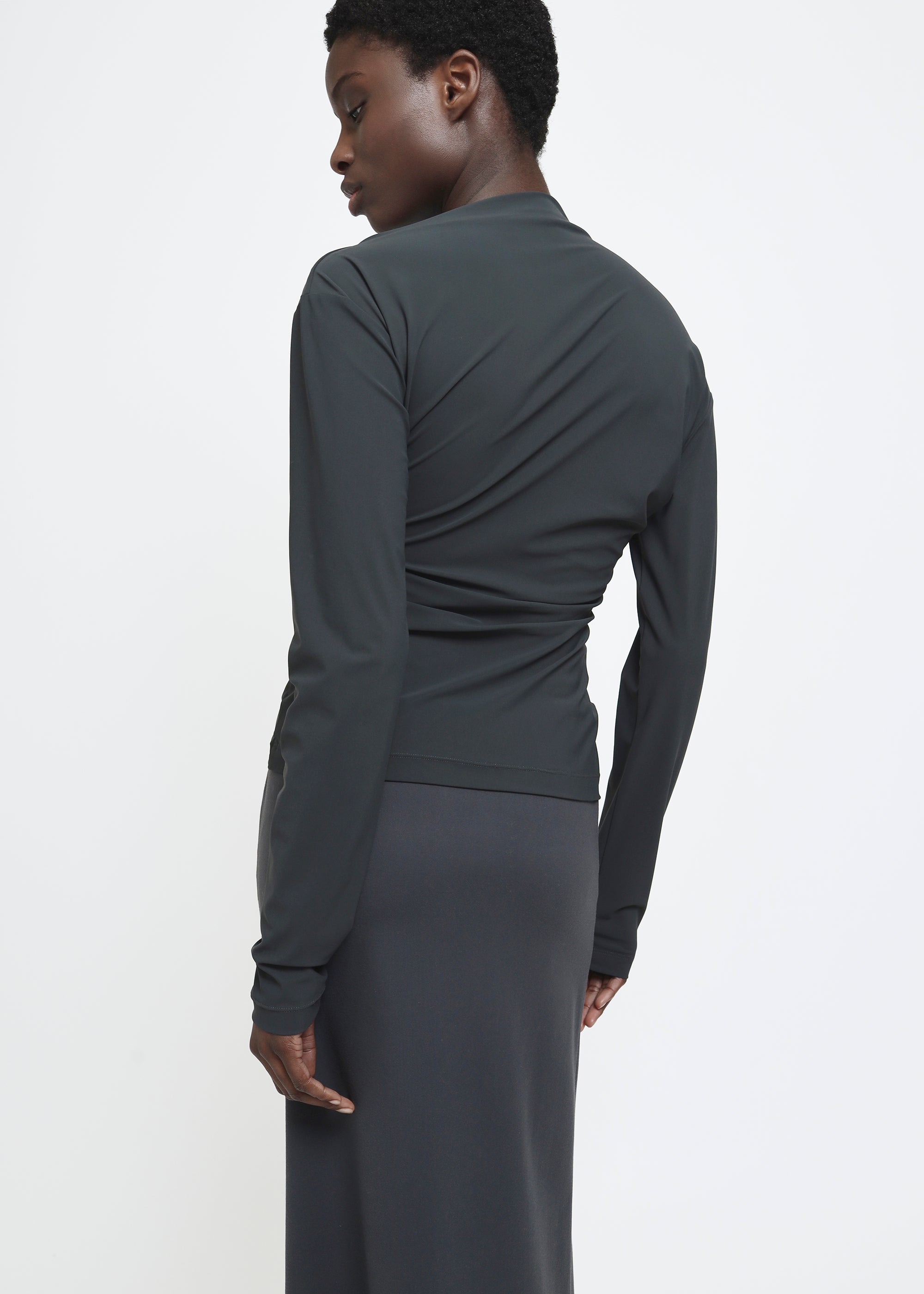 A dark charcoal gray long-sleeve top.
