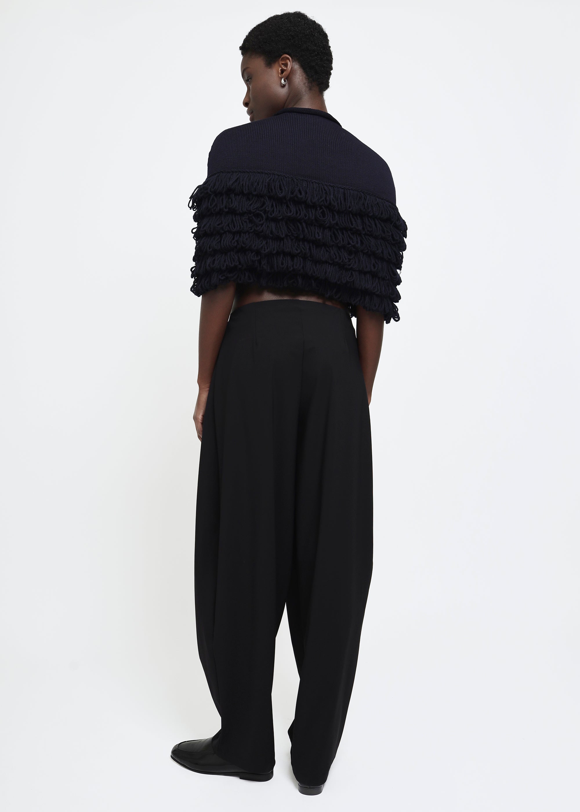 A navy hand-looped tiered fringe wool cape.