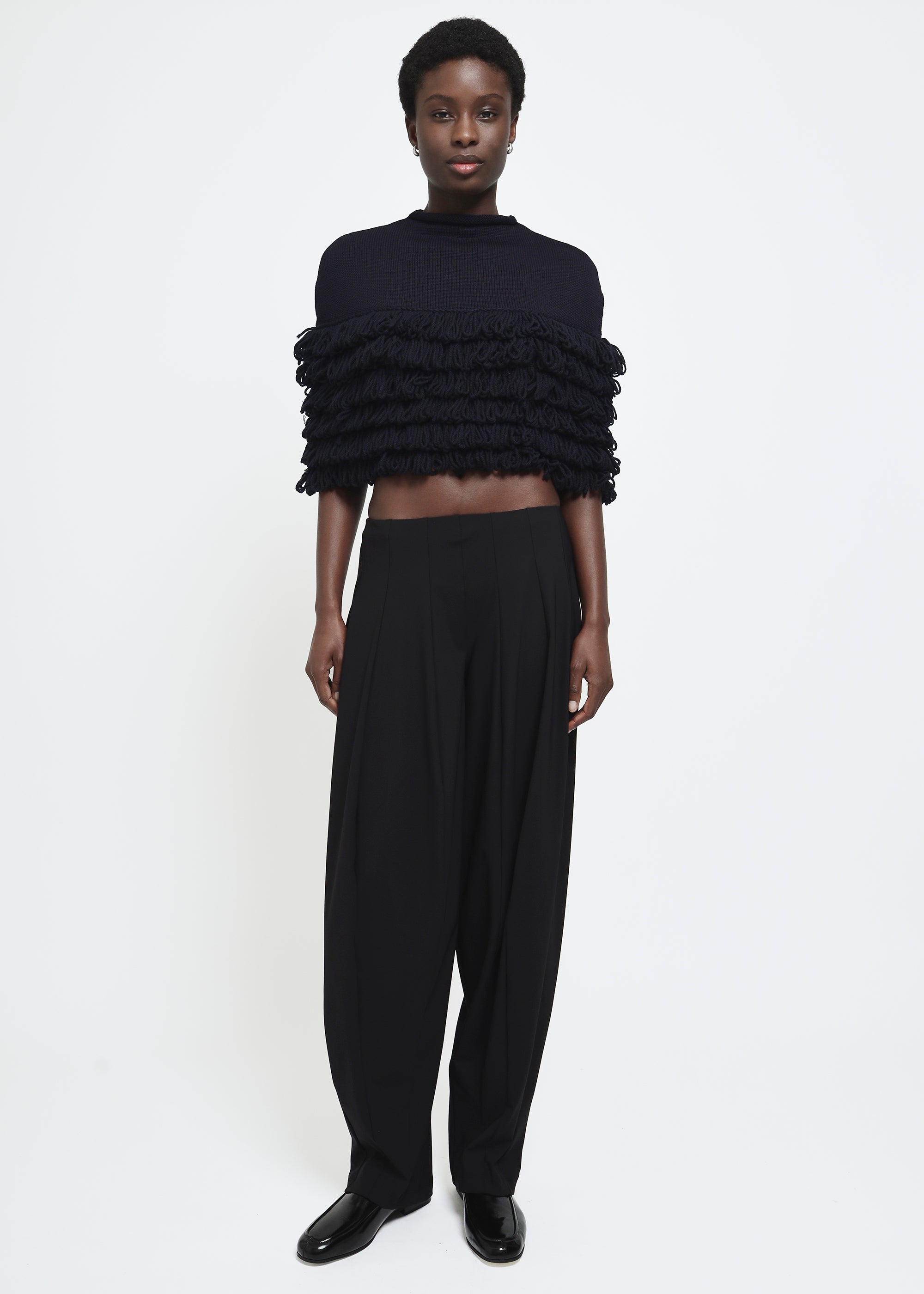 A navy hand-looped tiered fringe wool cape.