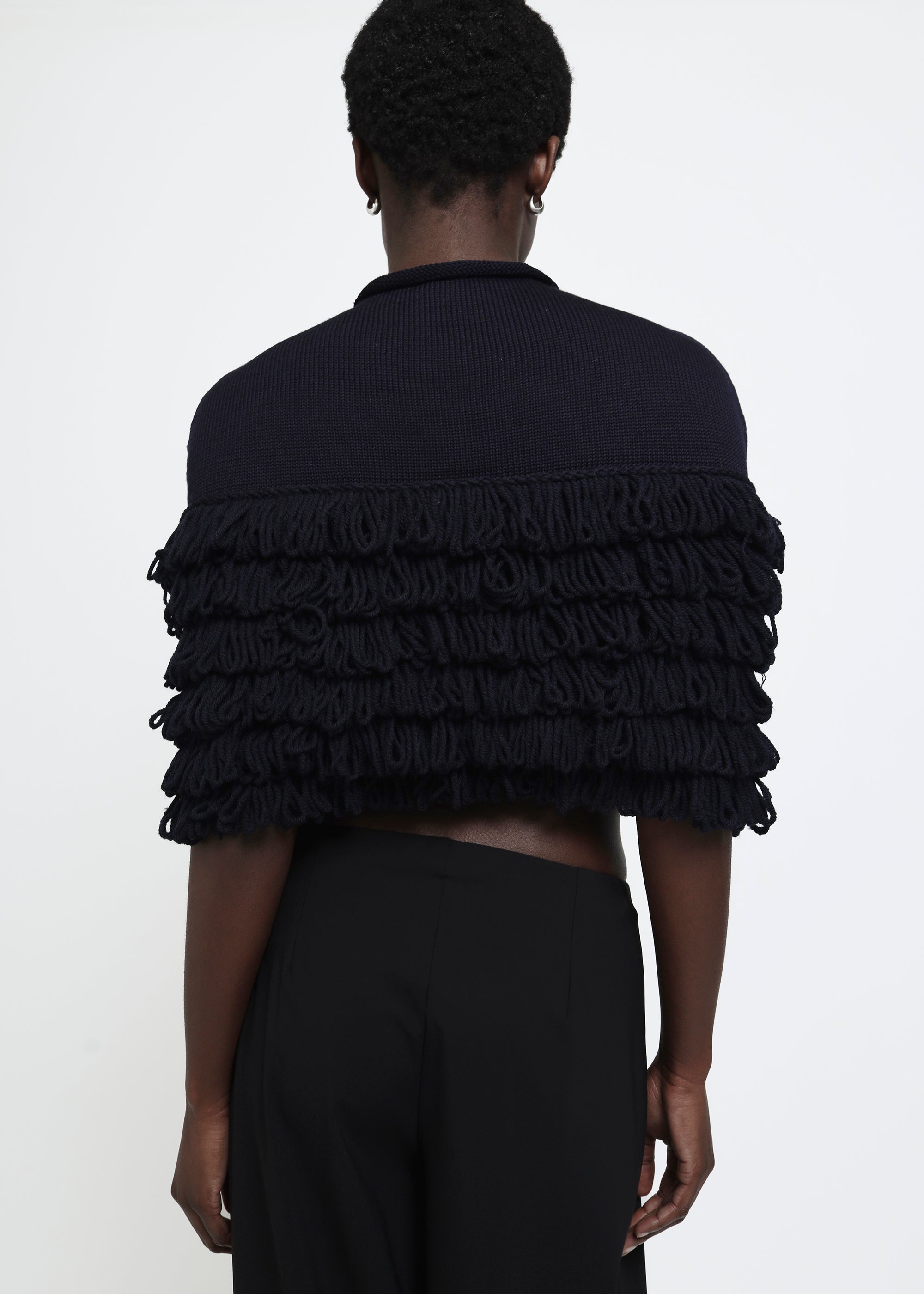 A navy hand-looped tiered fringe wool cape.