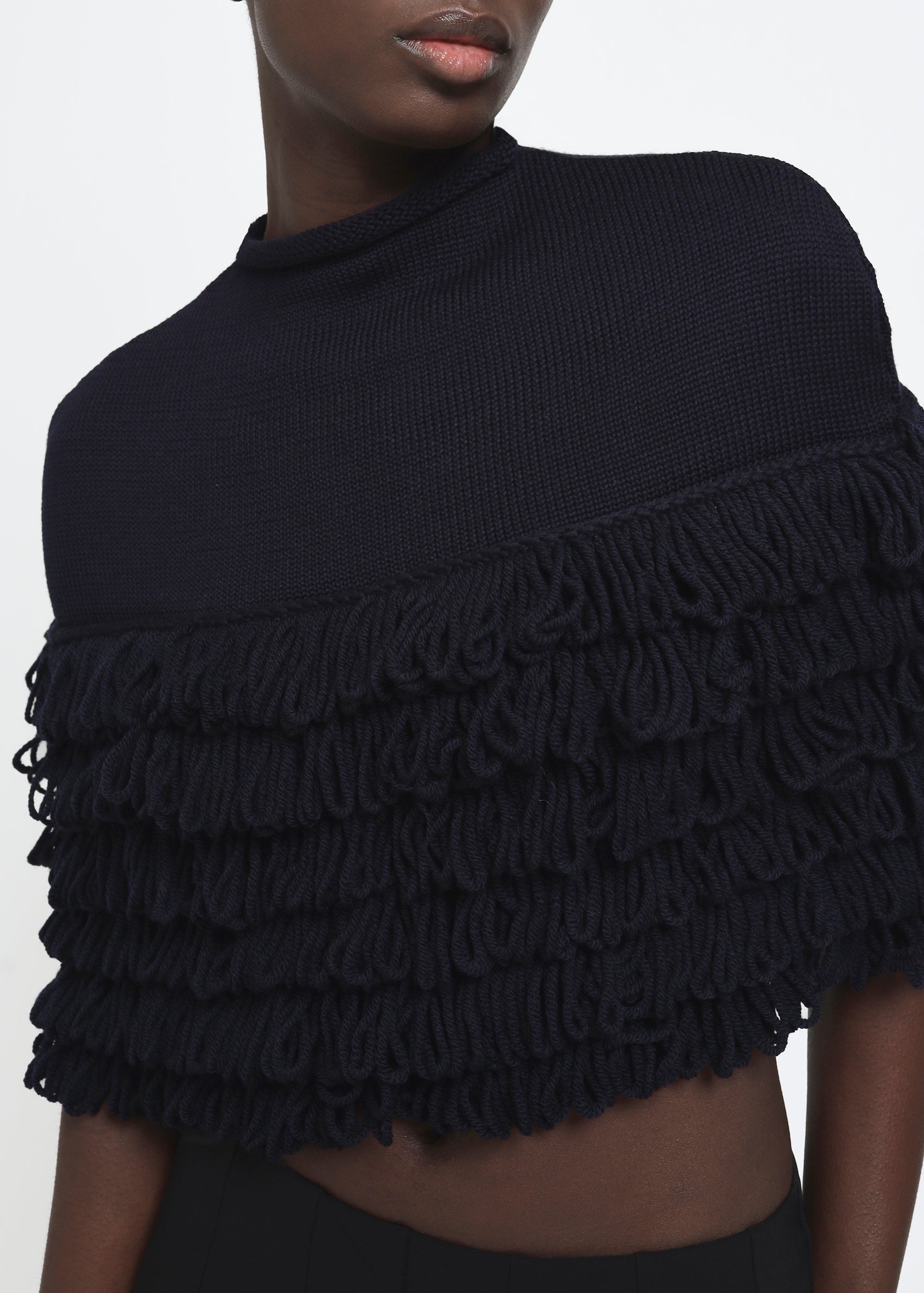 A navy hand-looped tiered fringe wool cape.
