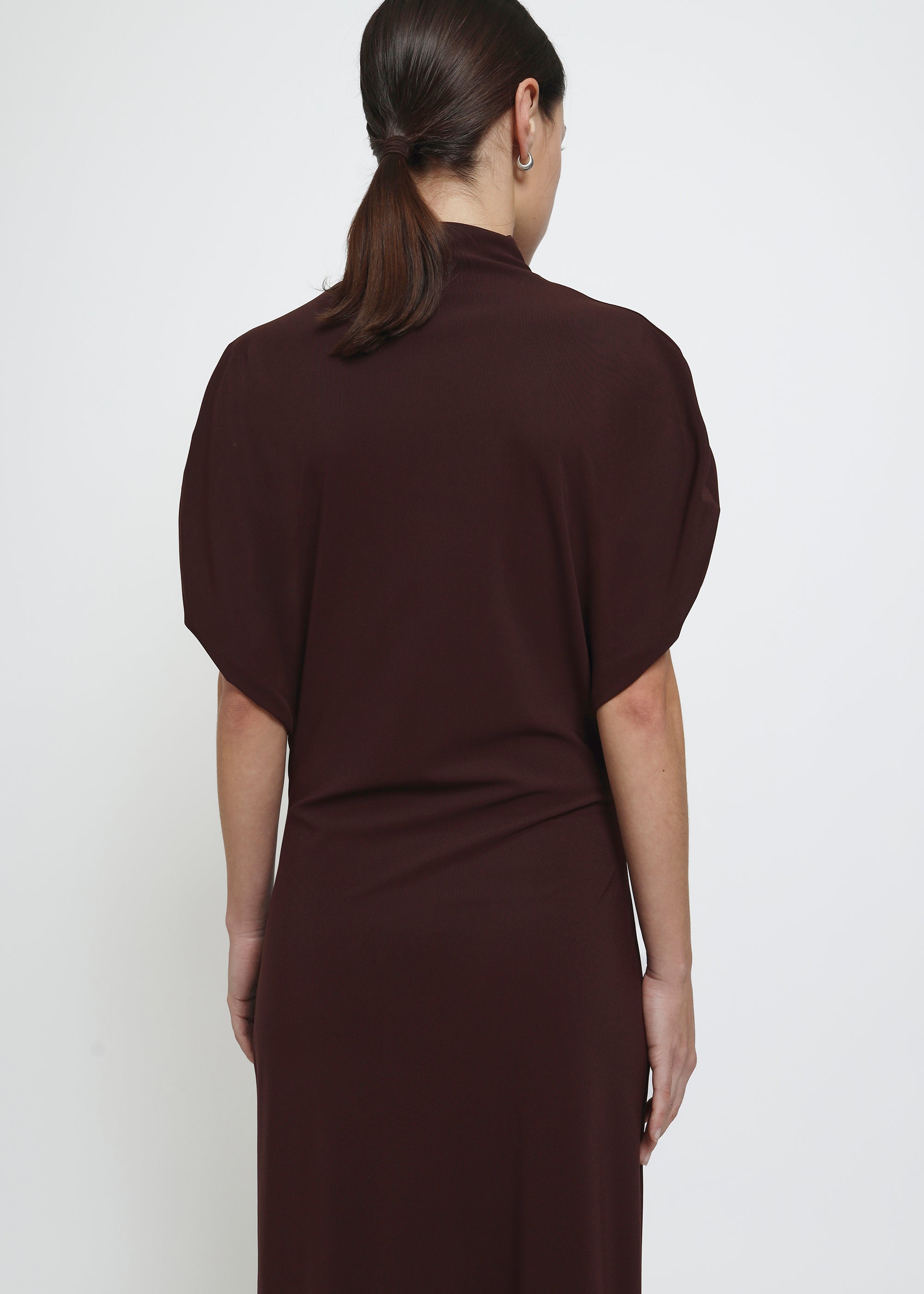 A dark brown red mock-neck dress with short puff sleeves.