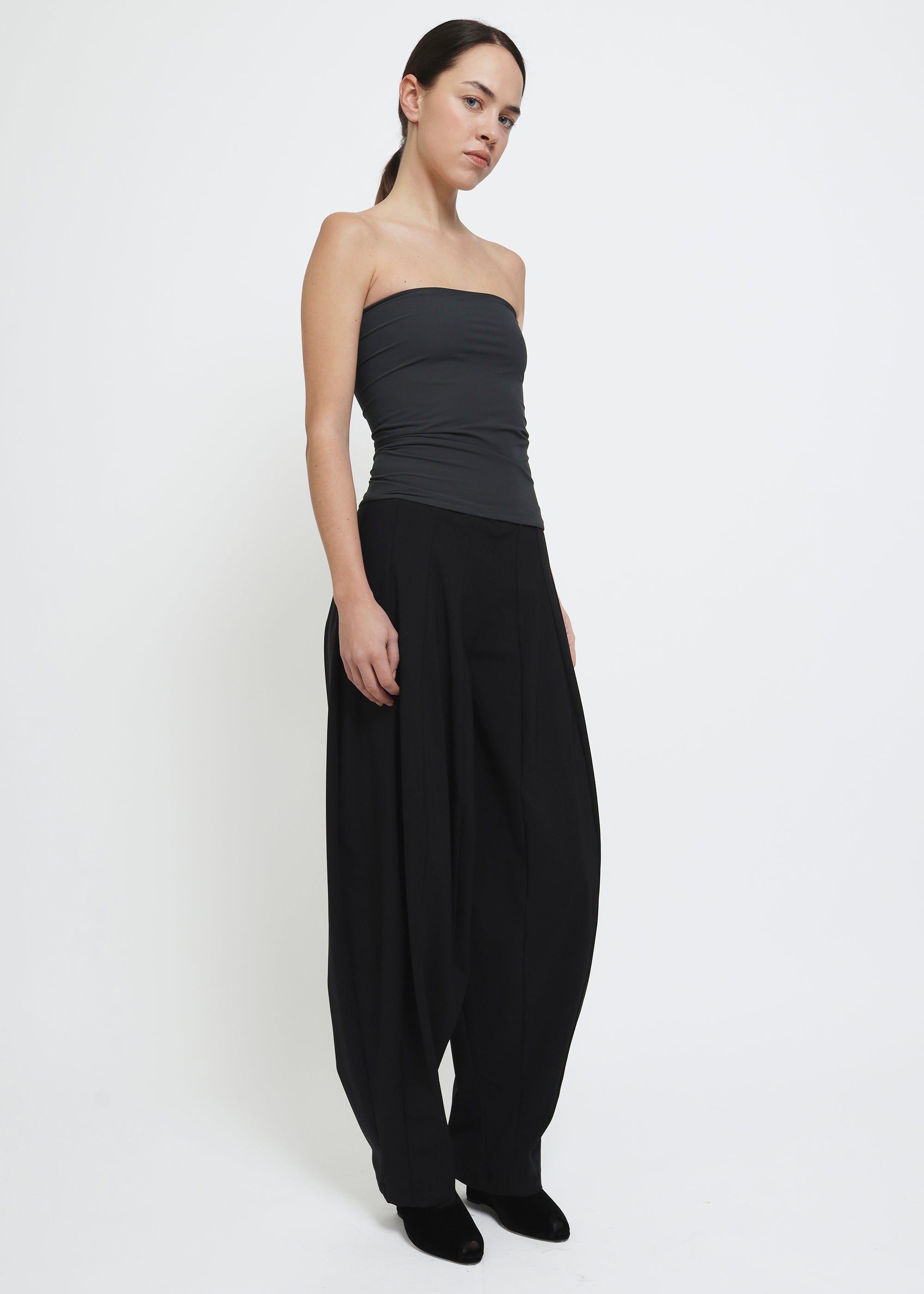 A wide-leg black curved trousers.