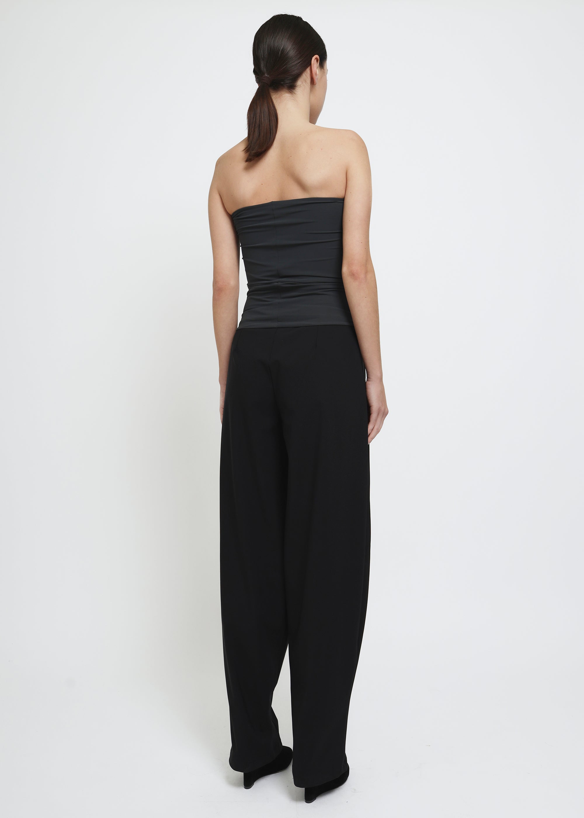 A wide-leg black curved trousers.