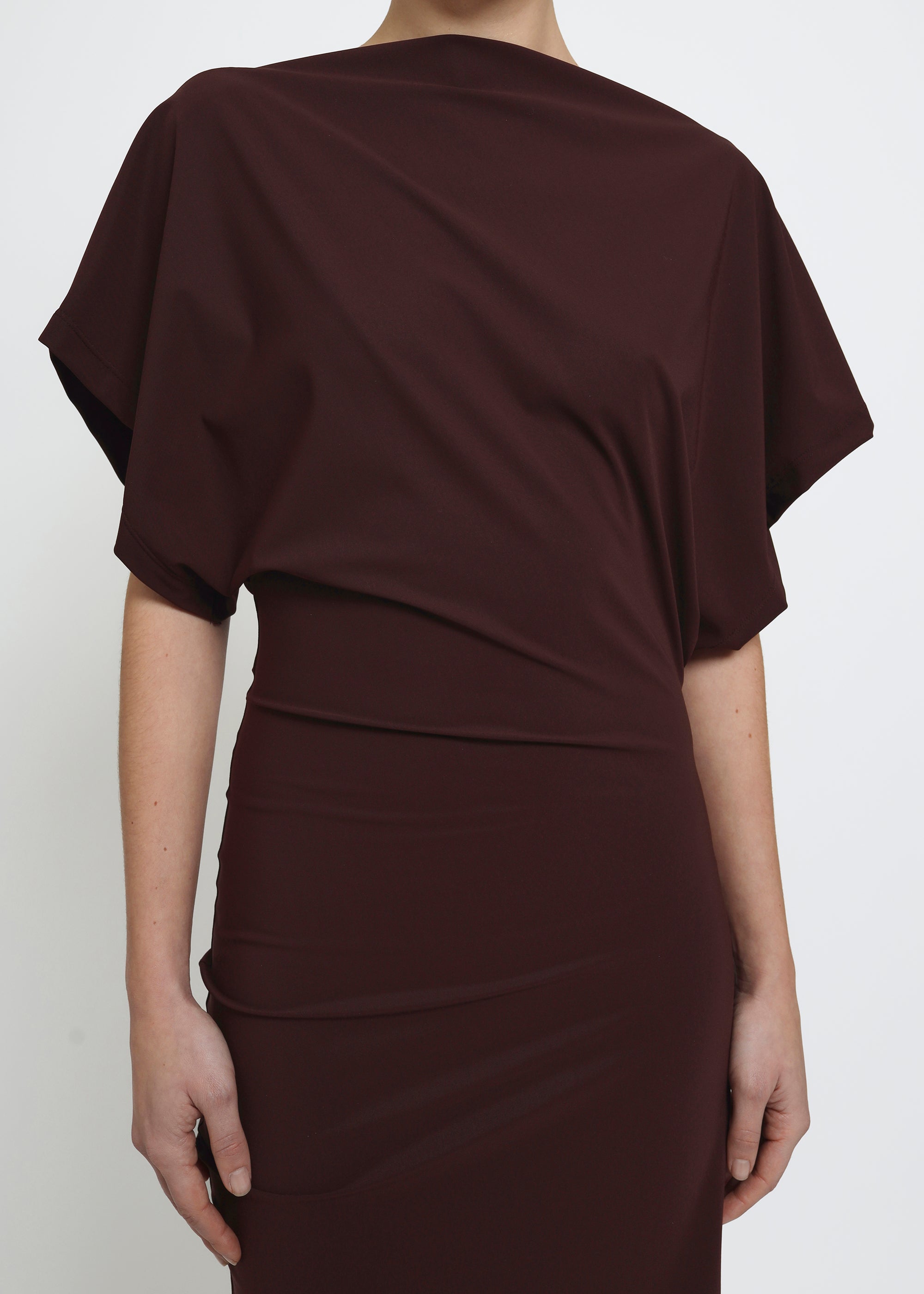 A dark red midi dress with draped short sleeves and a gathered waist.