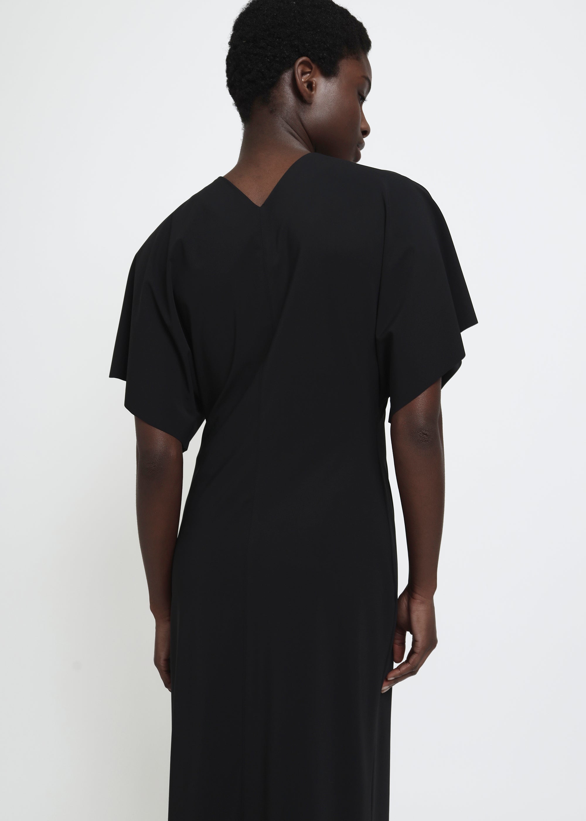 A black midi dress with short flutter sleeves.