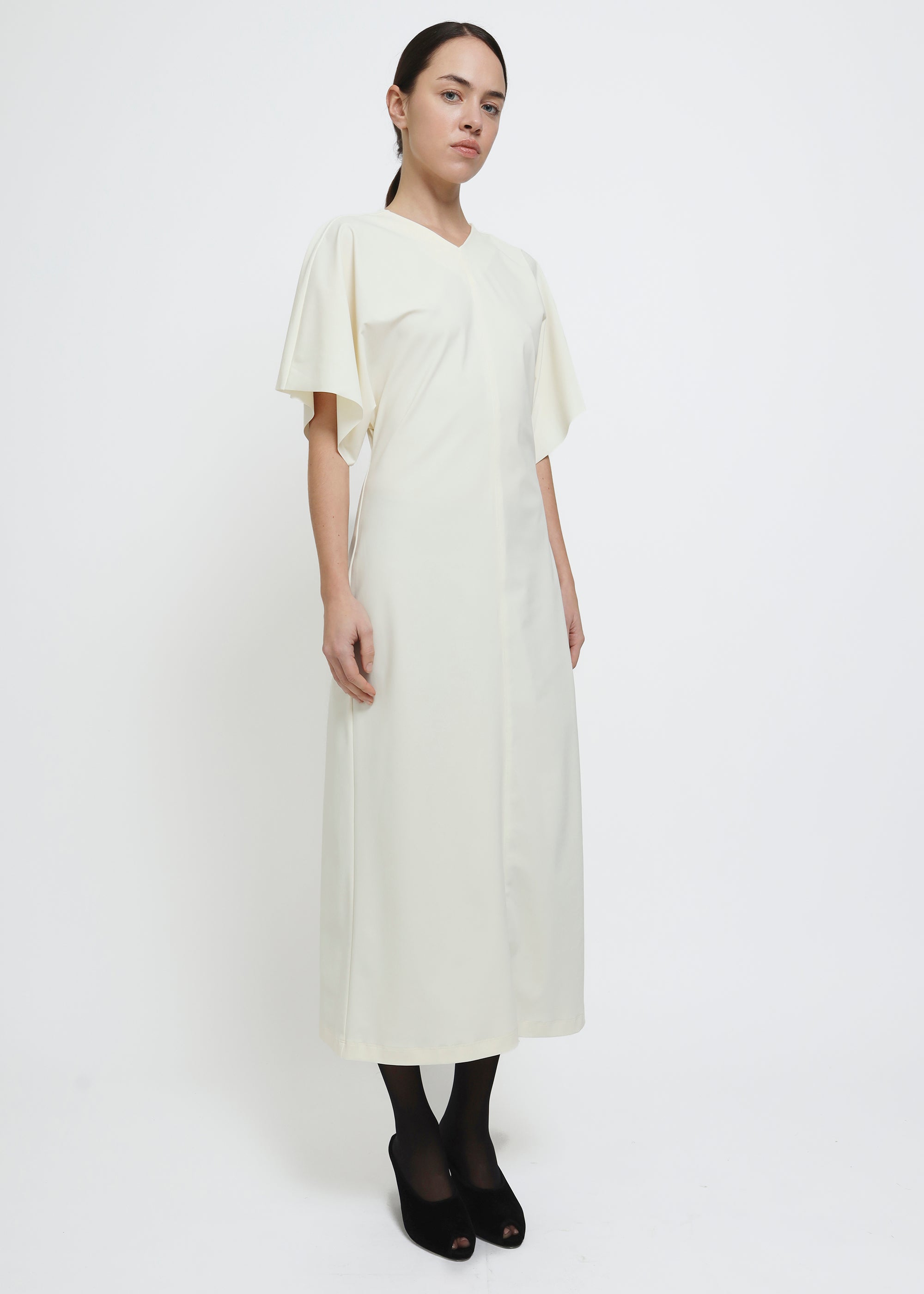 A cream-colored midi dress with short flutter sleeves.