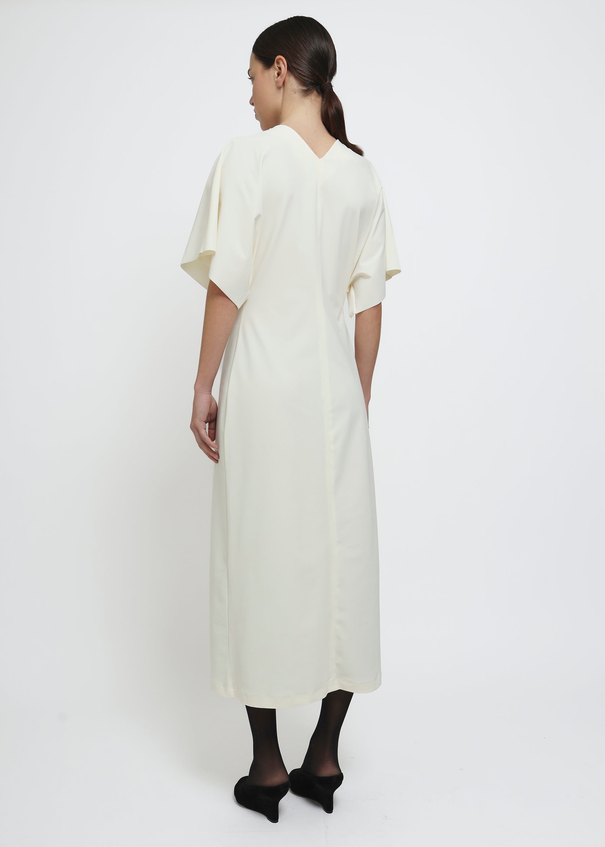 A cream-colored midi dress with short flutter sleeves.
