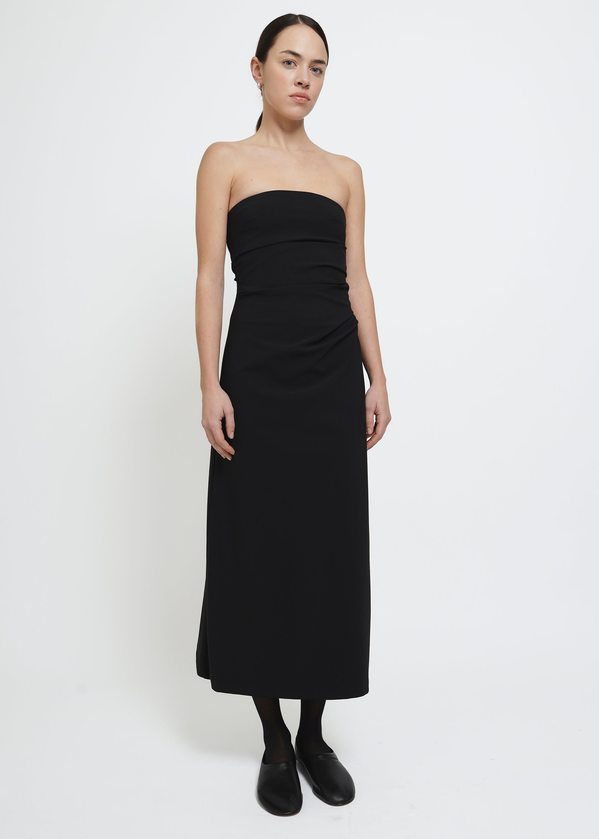 A strapless black midi dress with a gathered waist.
