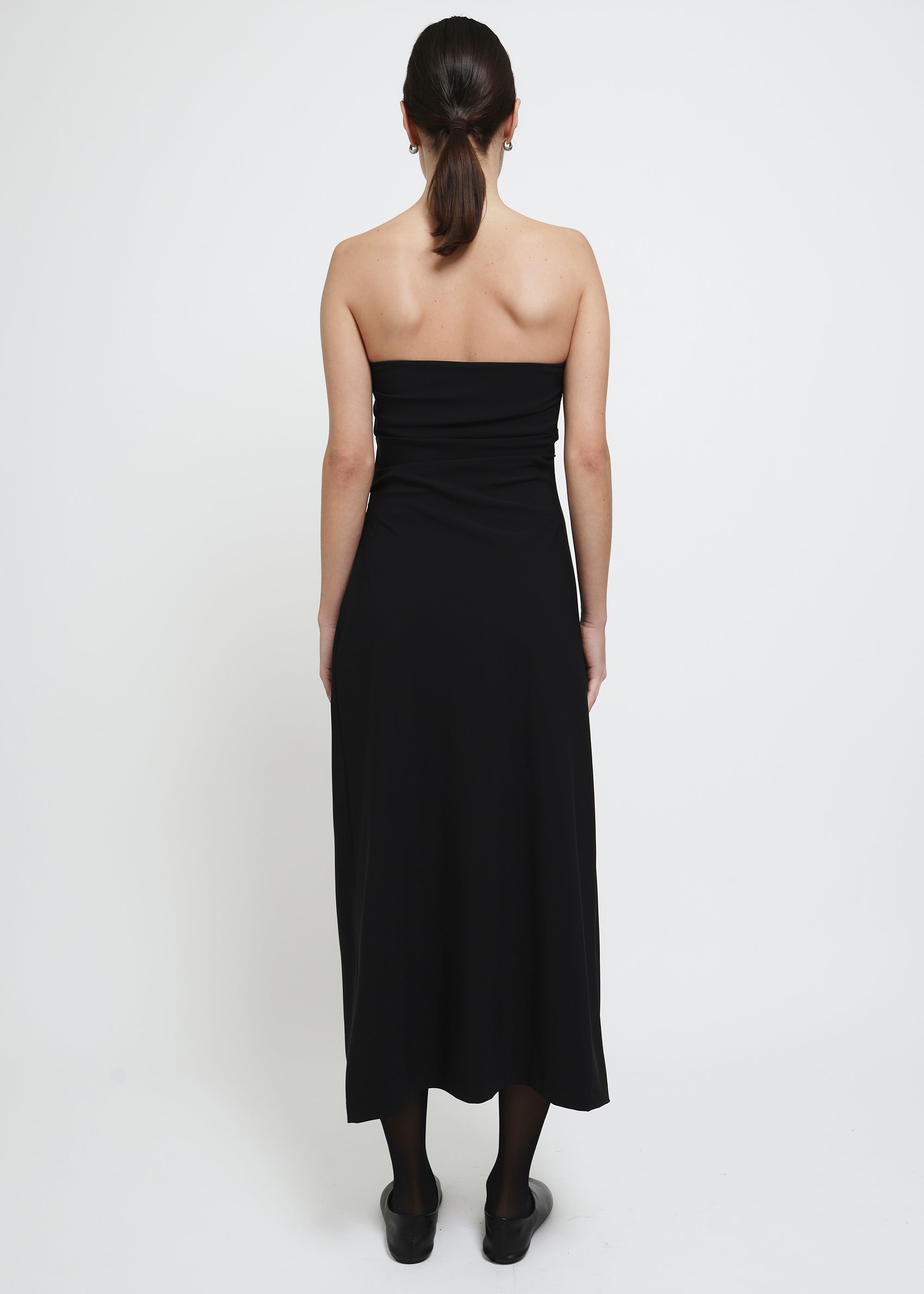 A strapless black midi dress with a gathered waist.