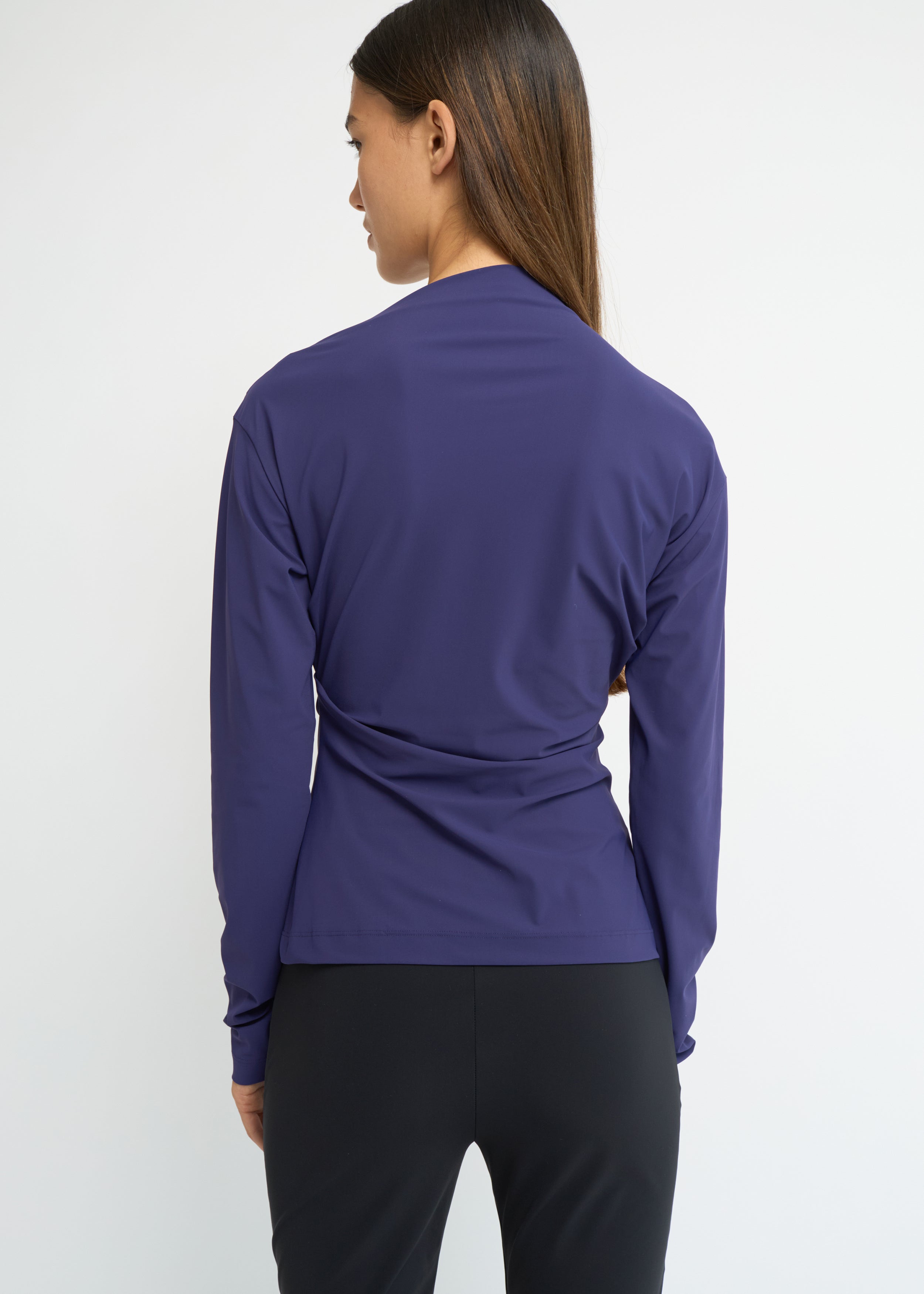 Violet long-sleeve top with an asymmetrical neckline and soft waist folds