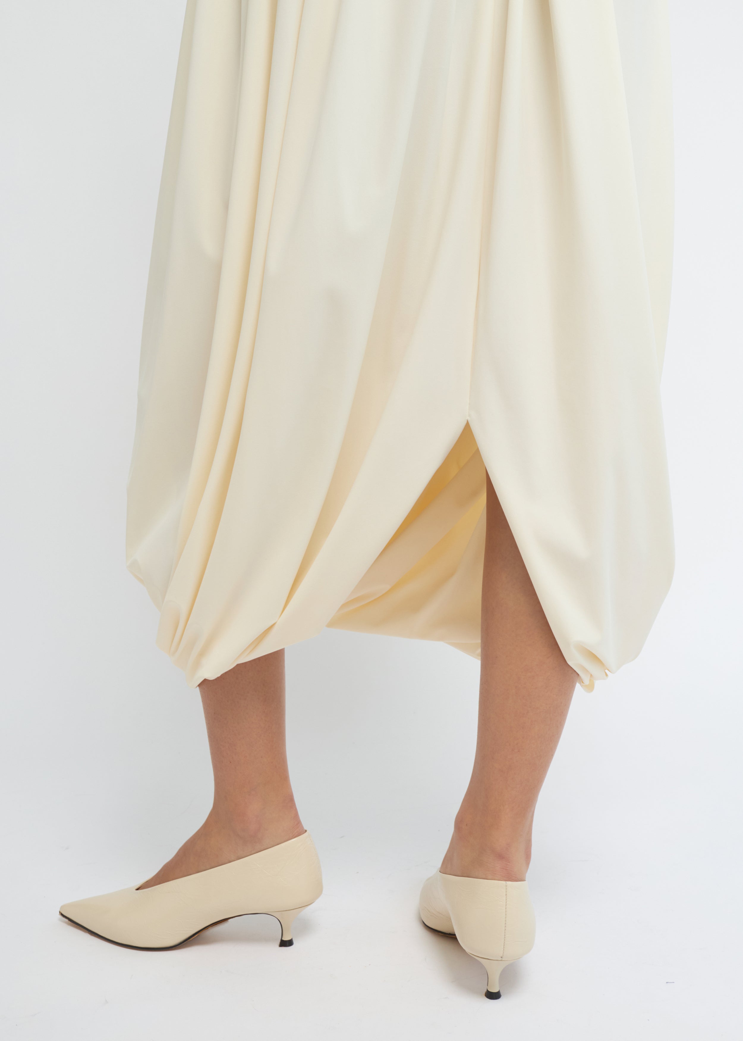 Cream balloon midi skirt with a voluminous, gathered silhouette