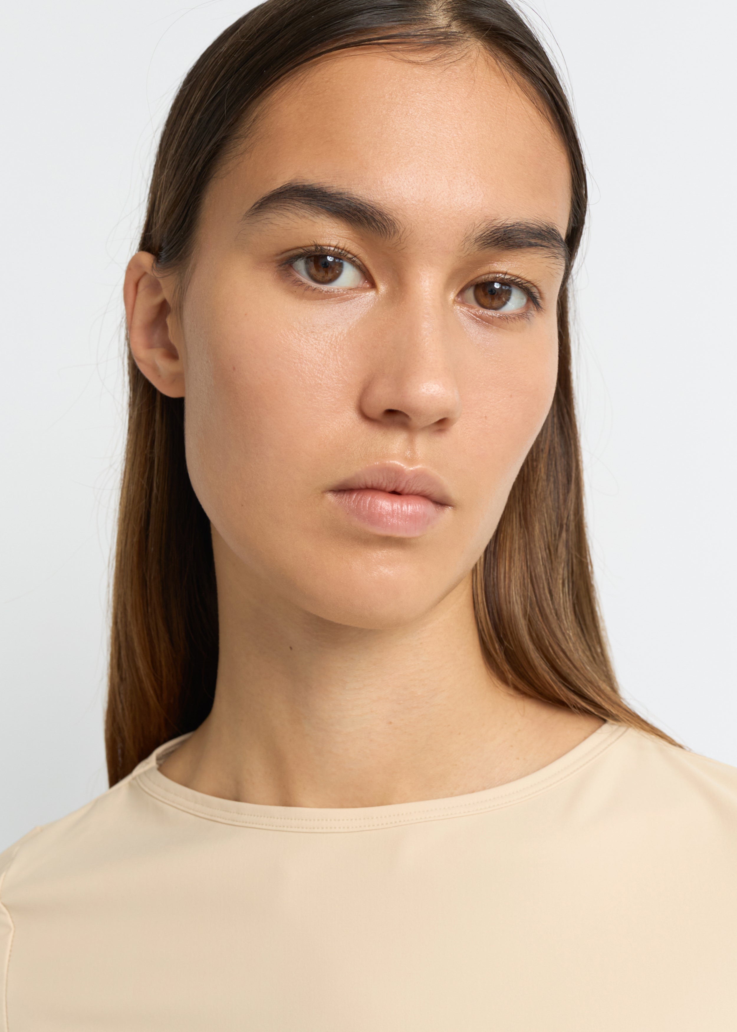 Sand cropped long-sleeve top with a boat neckline and fitted silhouette