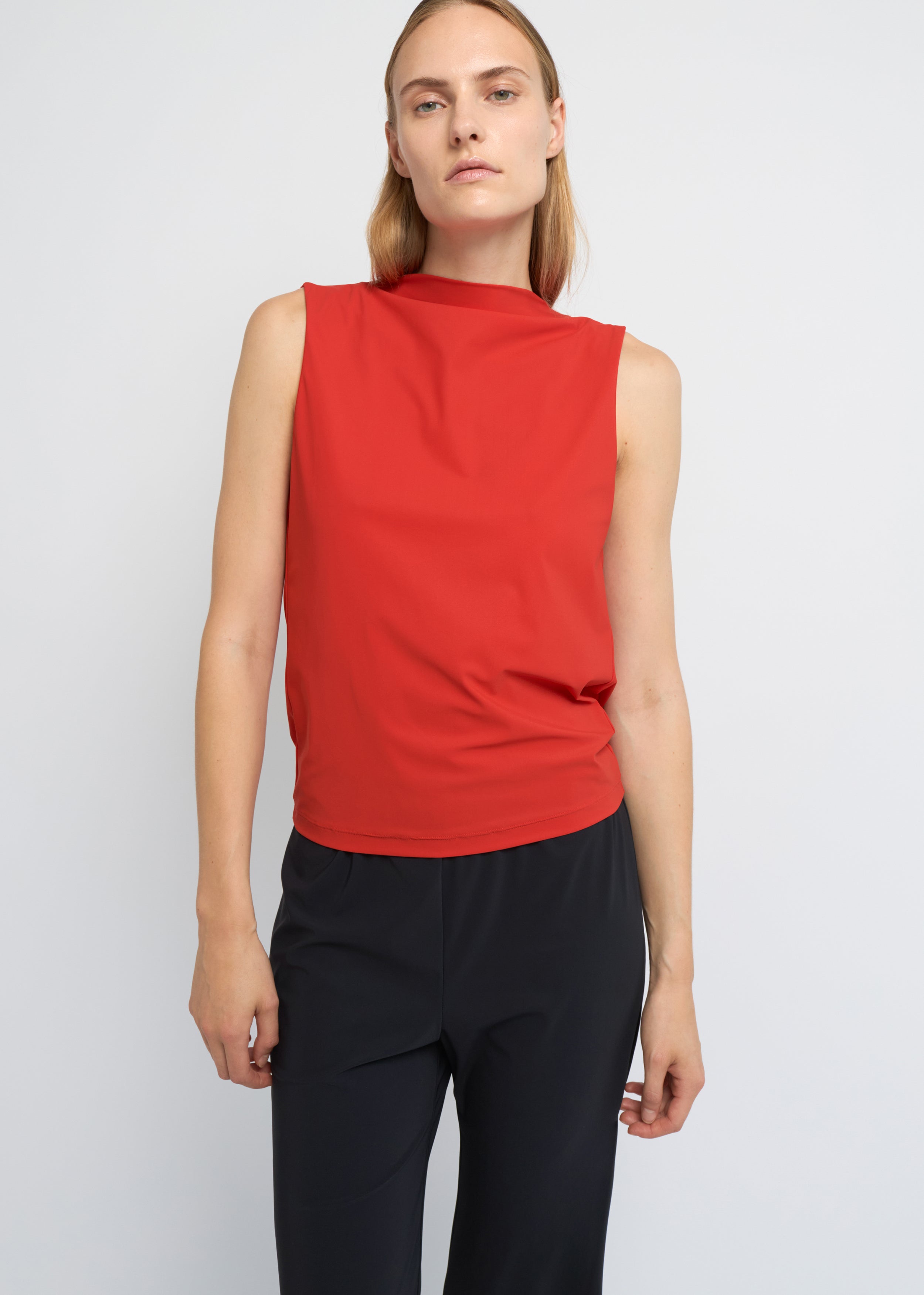 Red sleeveless top with a high neckline and softly draped open back