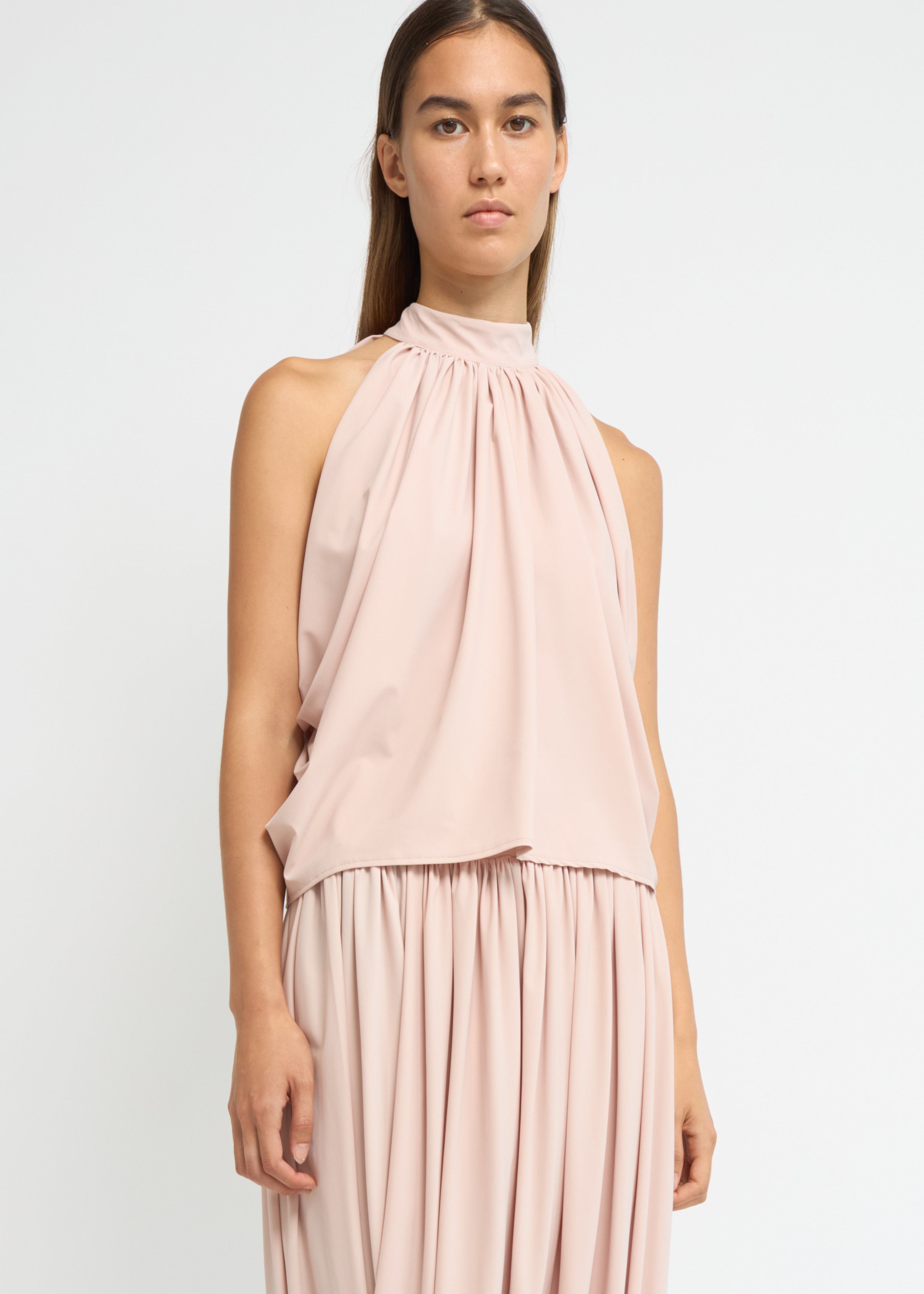 Blush sleeveless balloon top with a gathered high neckline and voluminous silhouette