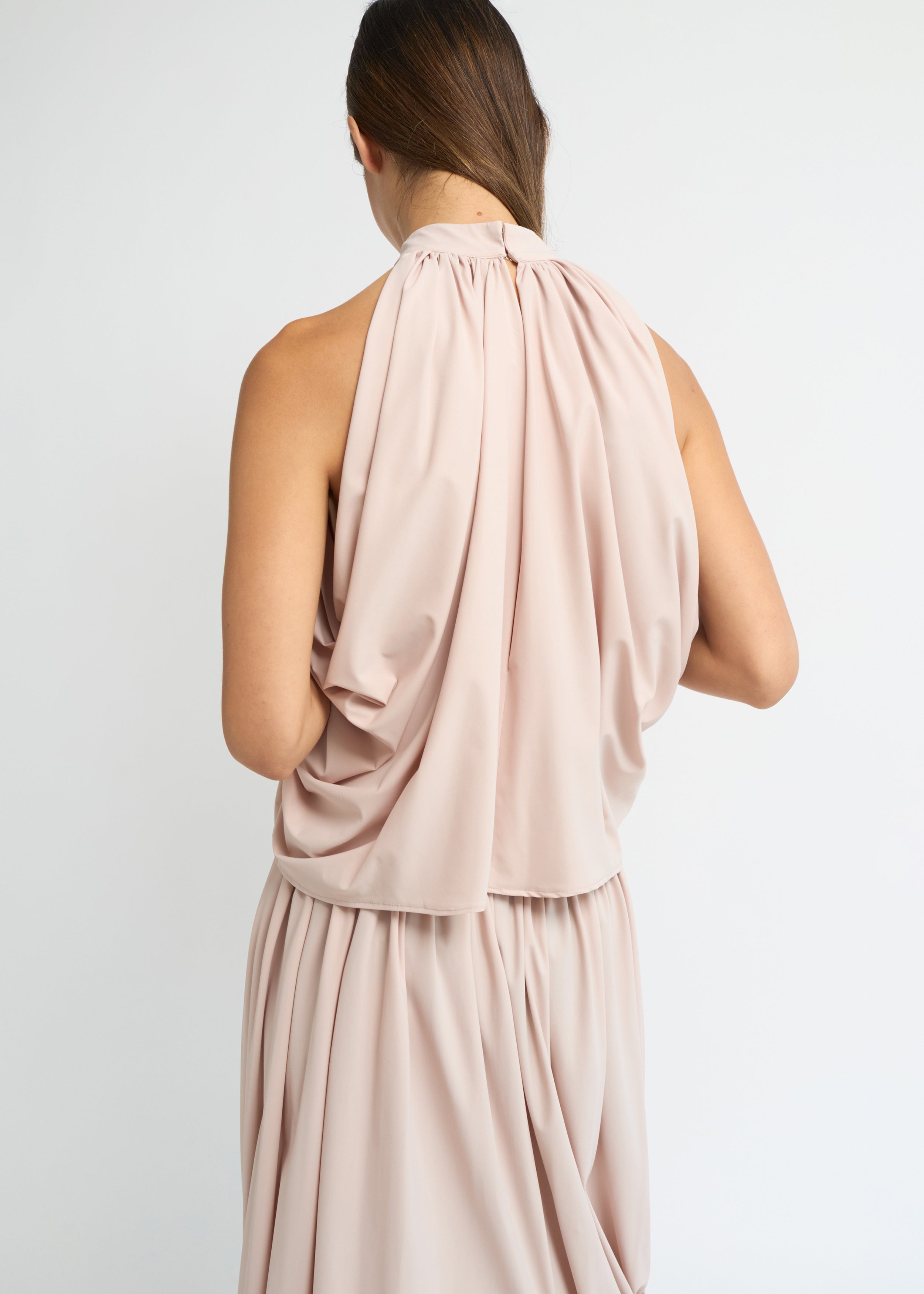 Blush sleeveless balloon top with a gathered high neckline and voluminous silhouette