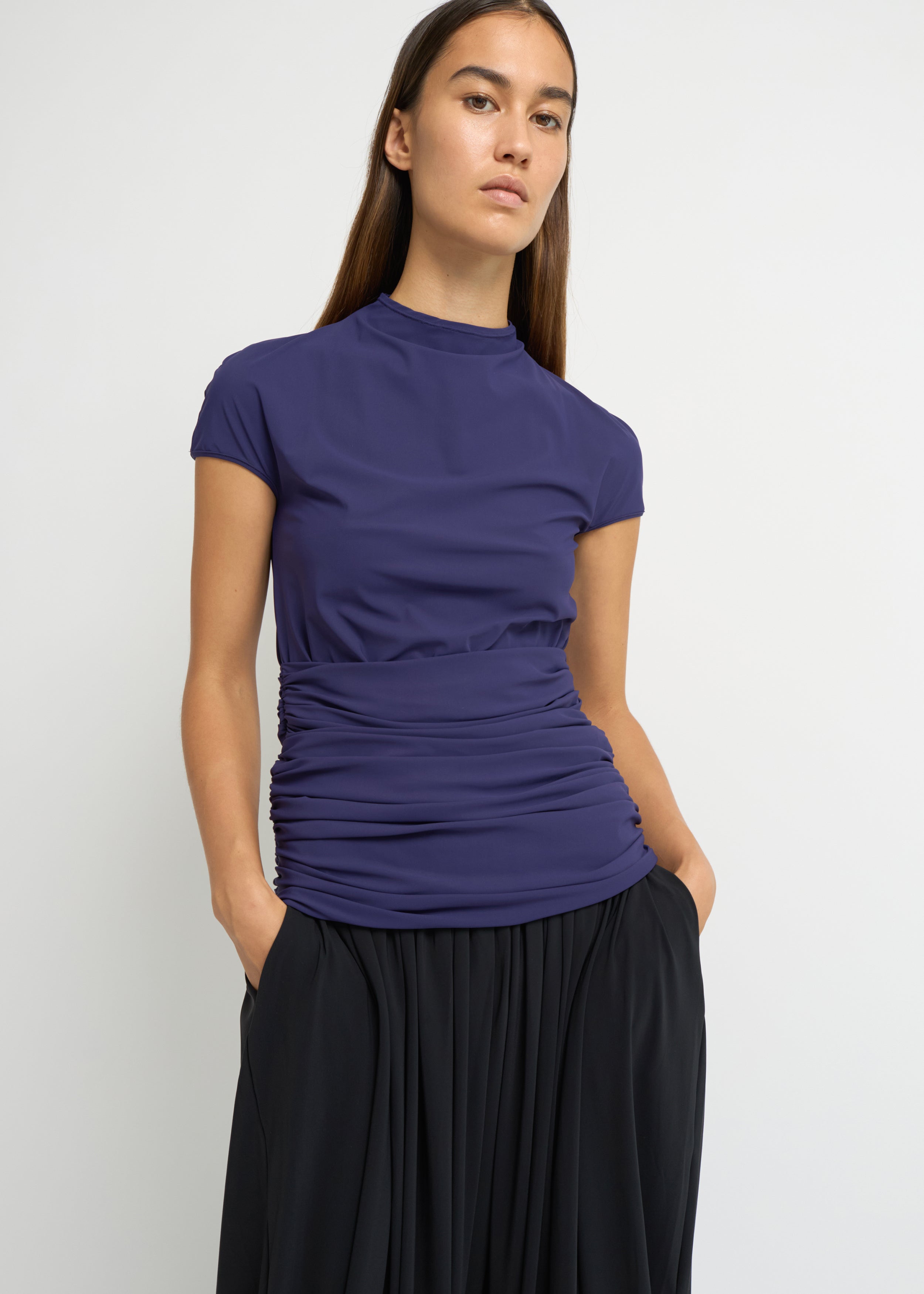 Violet fitted short-sleeve top with a high neckline and soft gathers at the waist