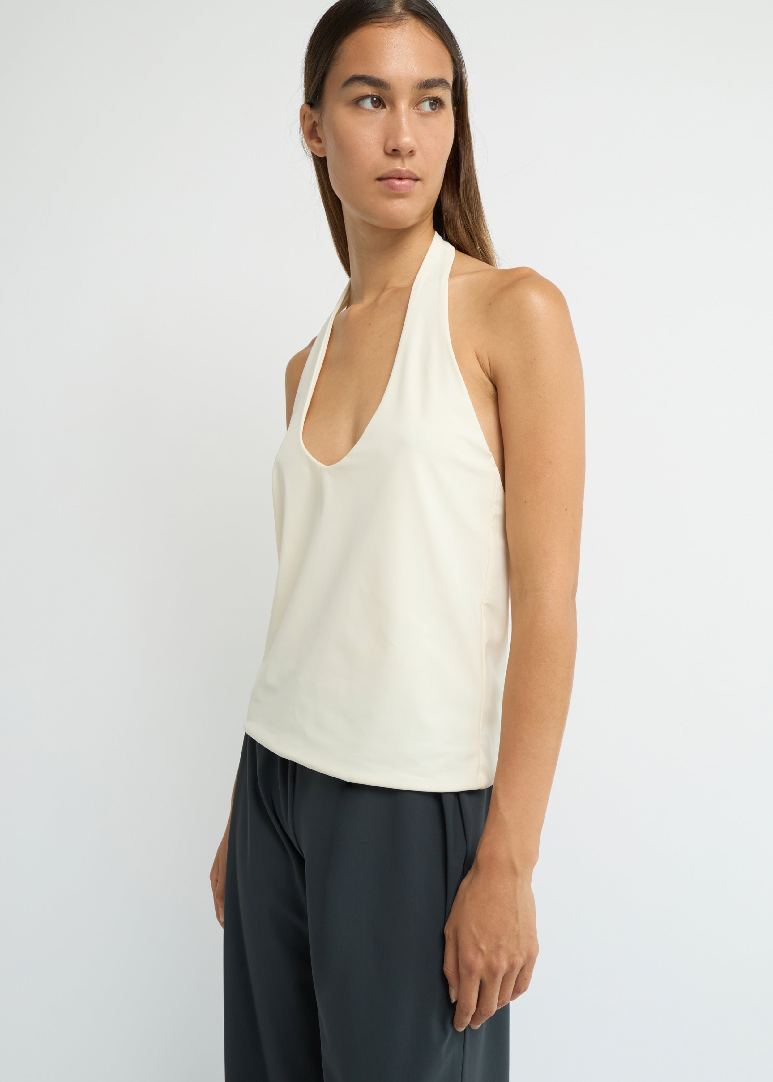Cream halter neck top with a deep scoop neckline and open back