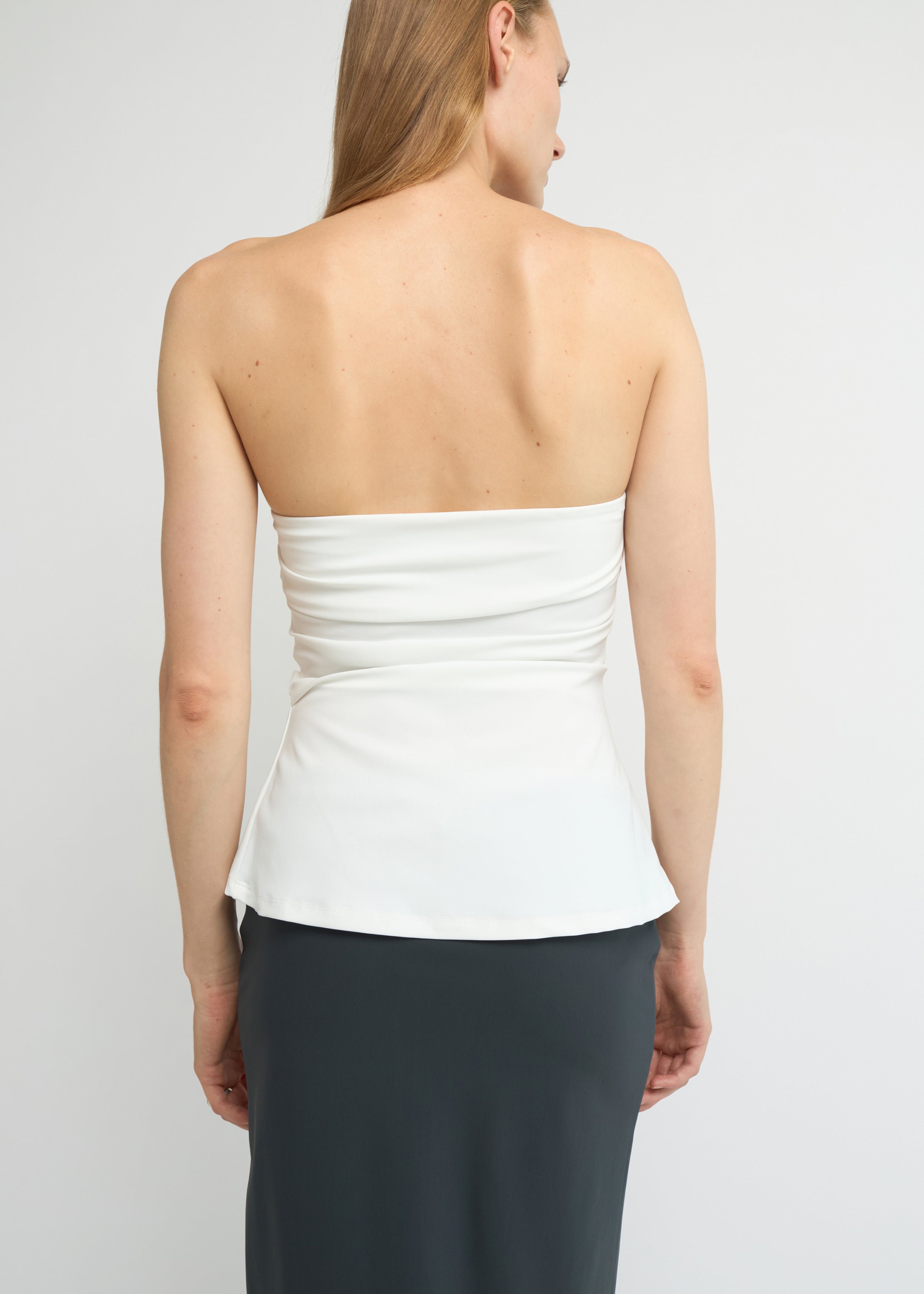 Off-white strapless top with a soft A-line shape and clean neckline