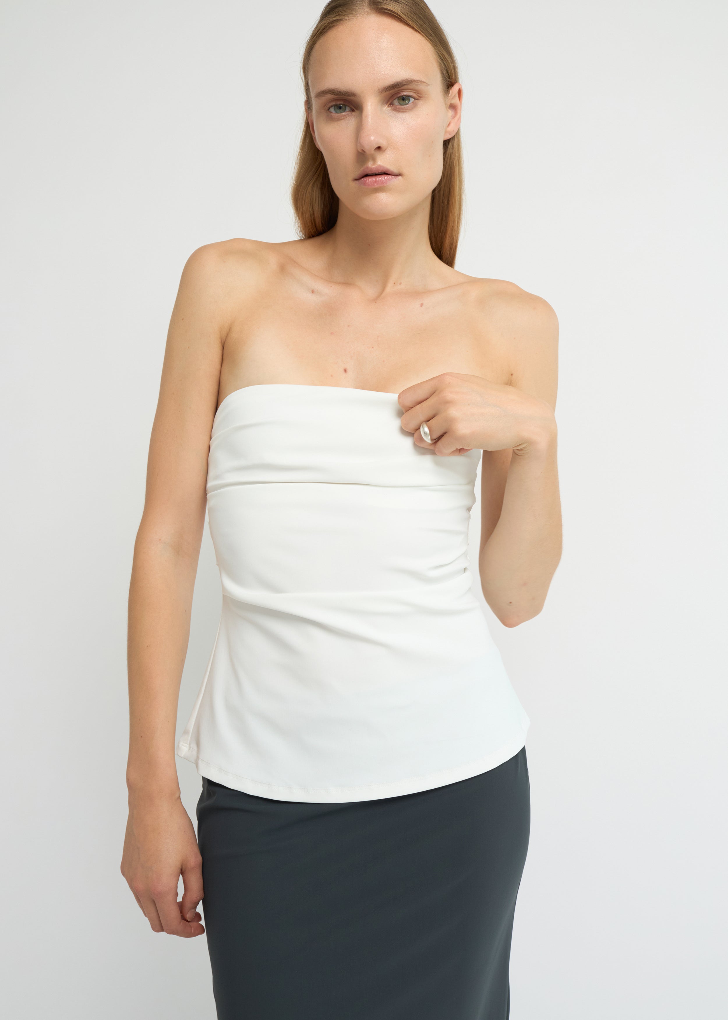 Off-white strapless top with a soft A-line shape and clean neckline