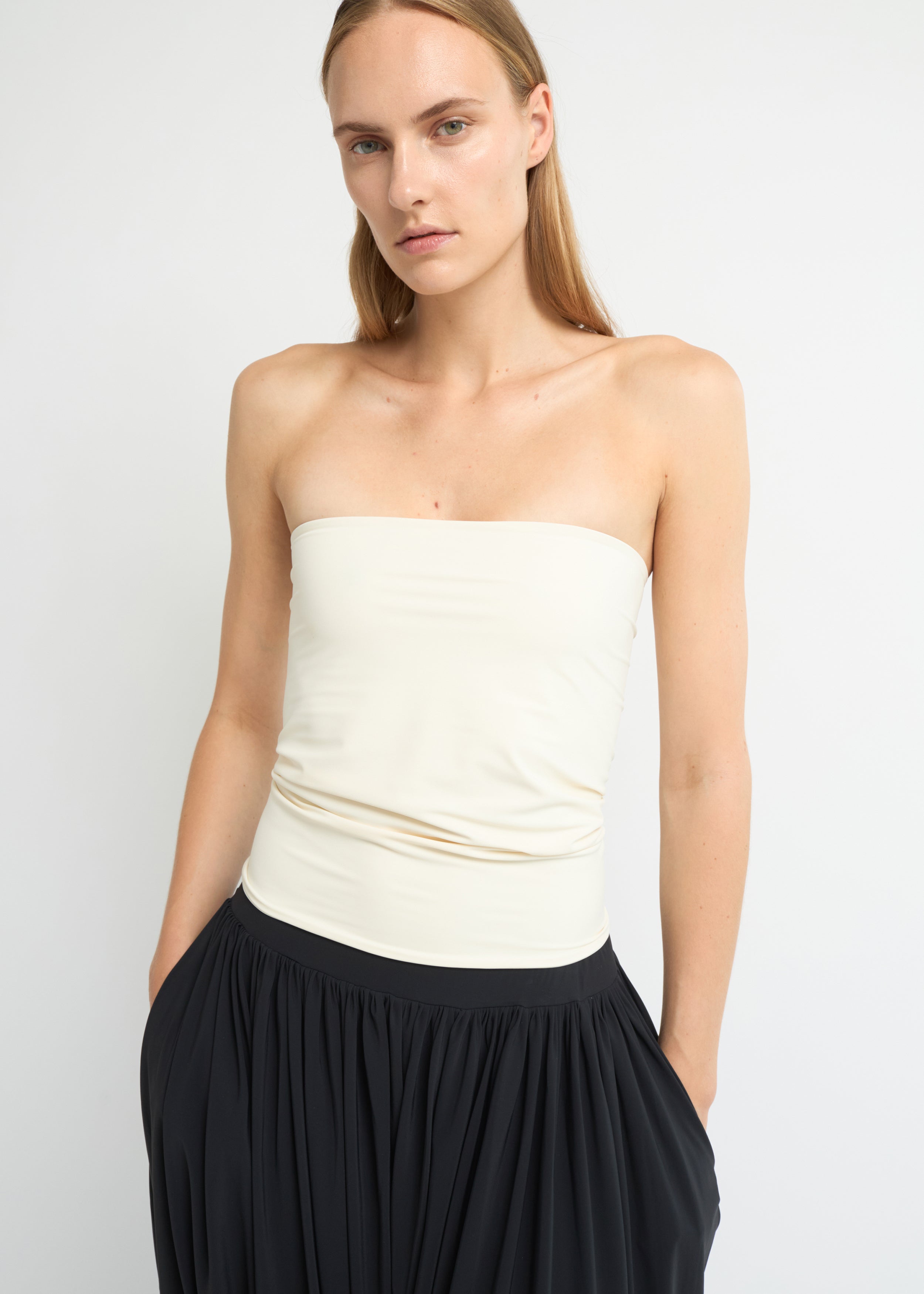 Cream strapless bandeau top with straight neckline and fitted silhouette