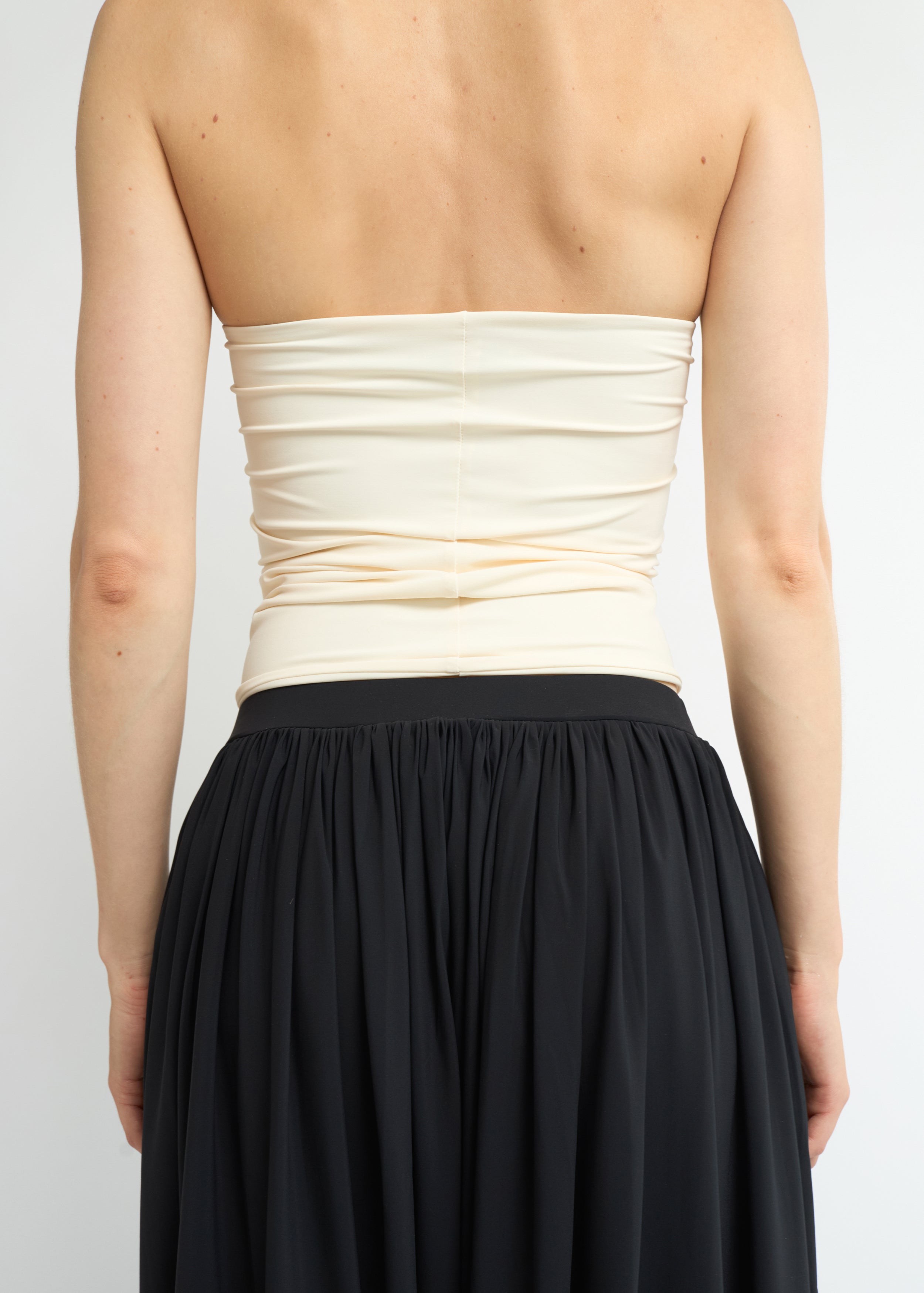 Cream strapless bandeau top with straight neckline and fitted silhouette