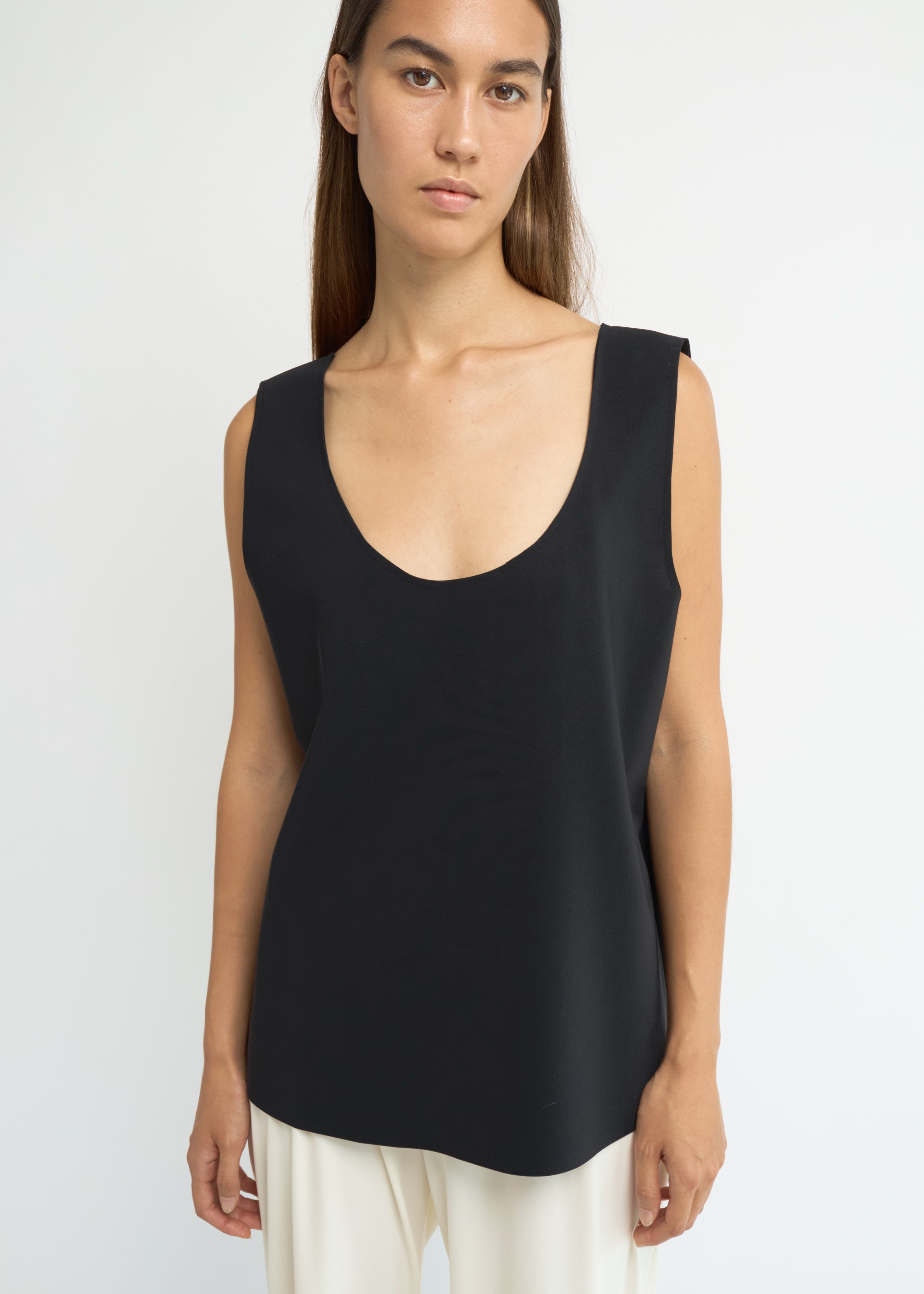 Black sleeveless scoop-neck top with a structured, elongated line