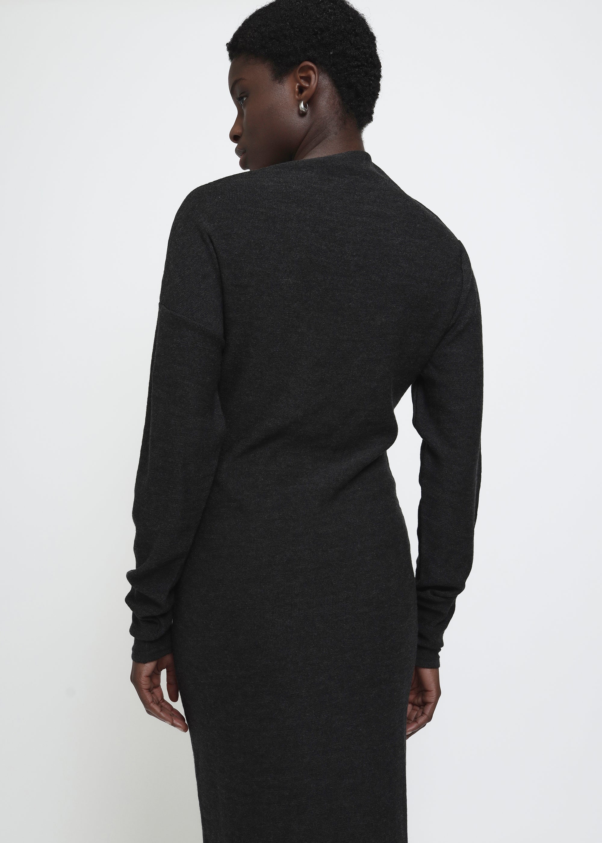 A dark gray knitted long-sleeve asymmetric mock neck midi dress.