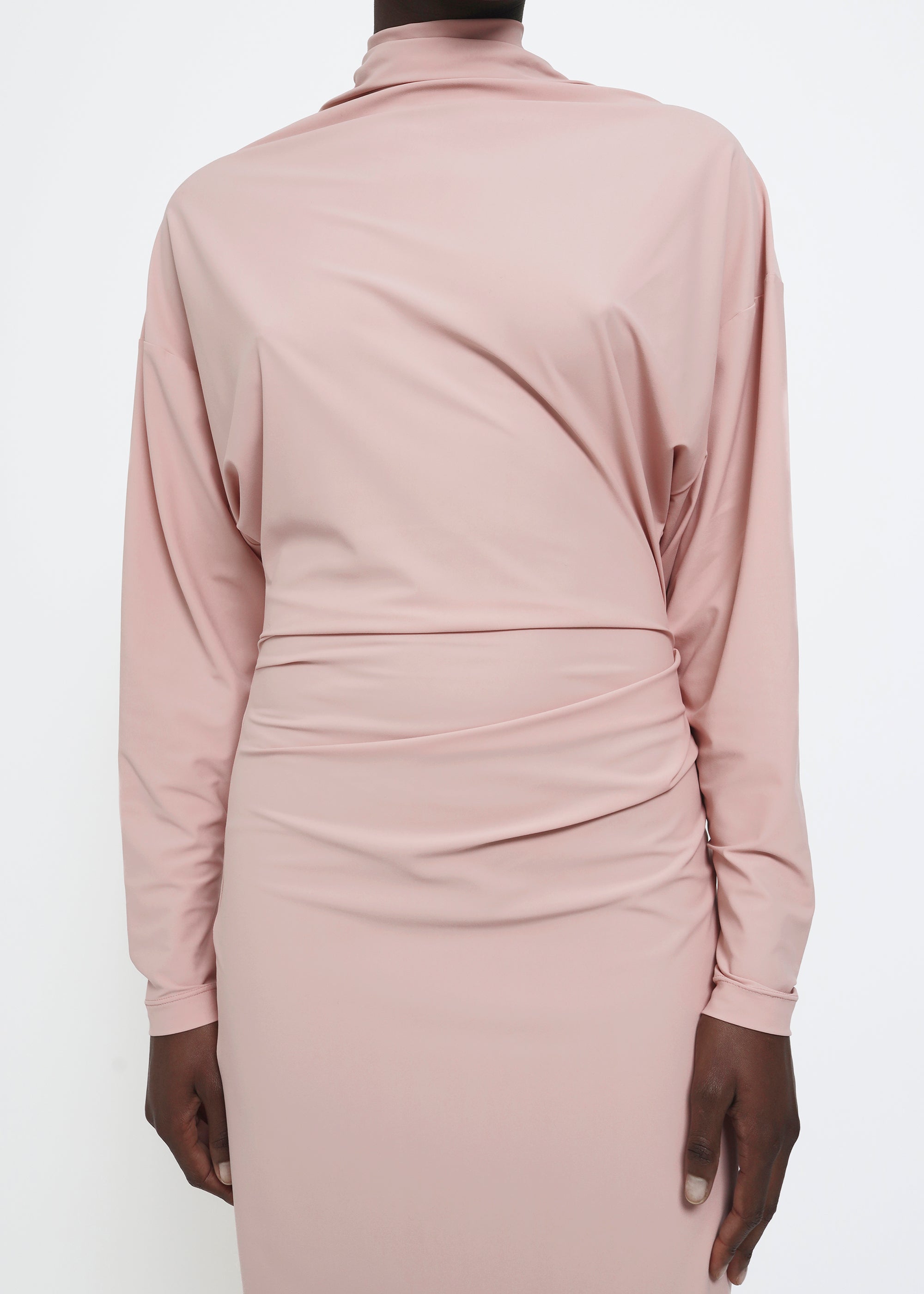 A dusty pink long-sleeve mock-neck midi dress with gathered detailing at the waist.