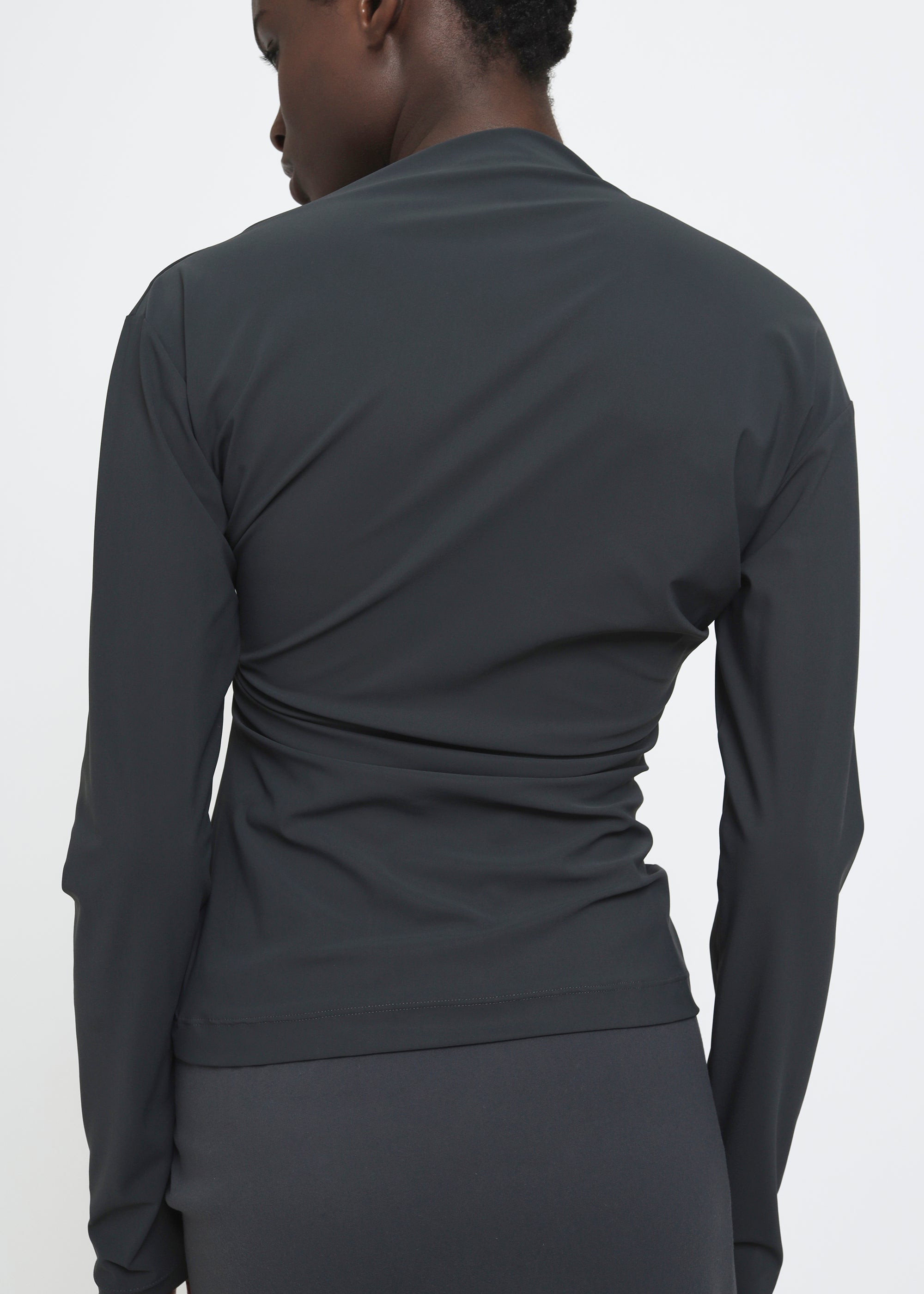 A dark charcoal gray long-sleeve top.