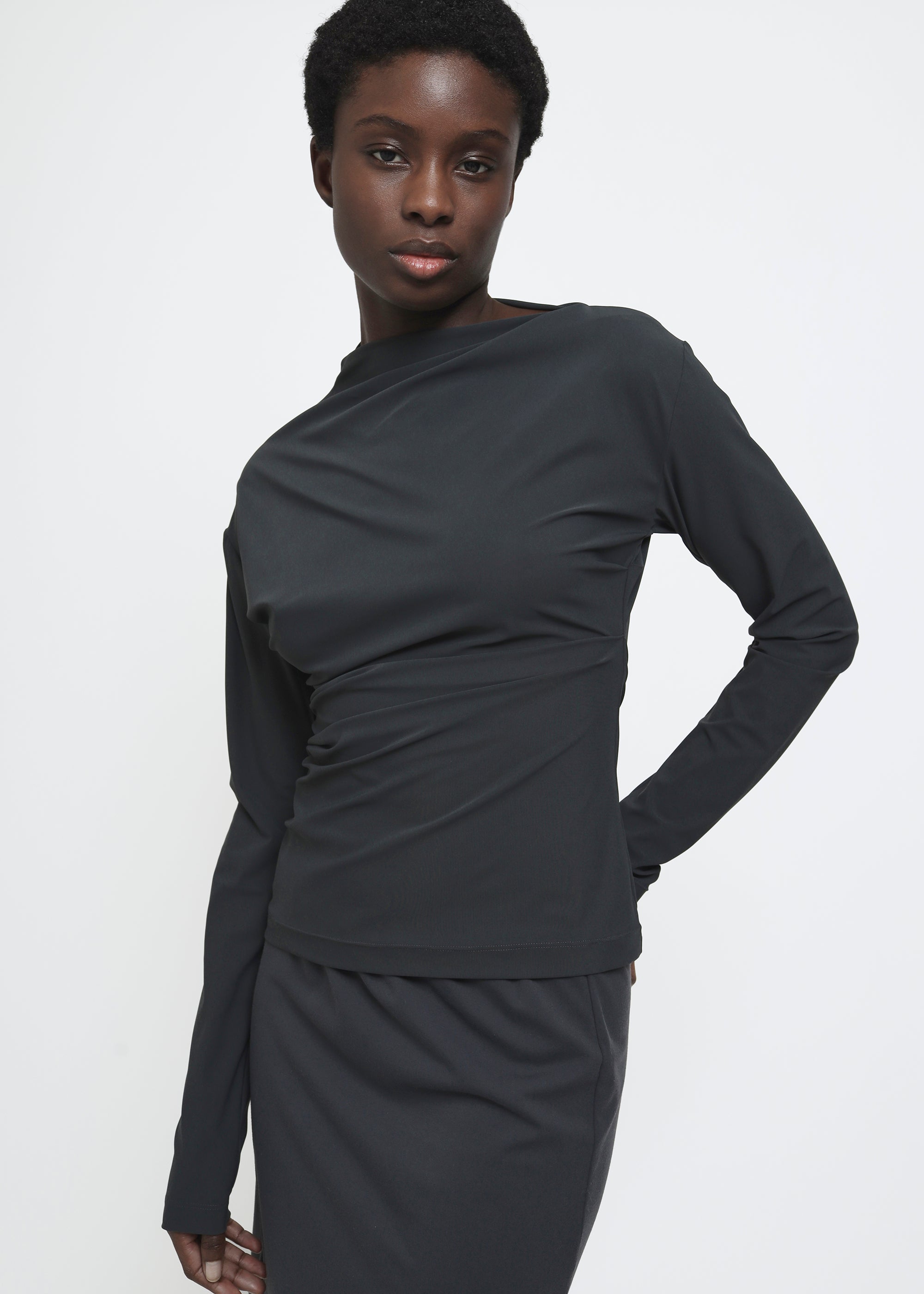 A dark charcoal gray long-sleeve top.