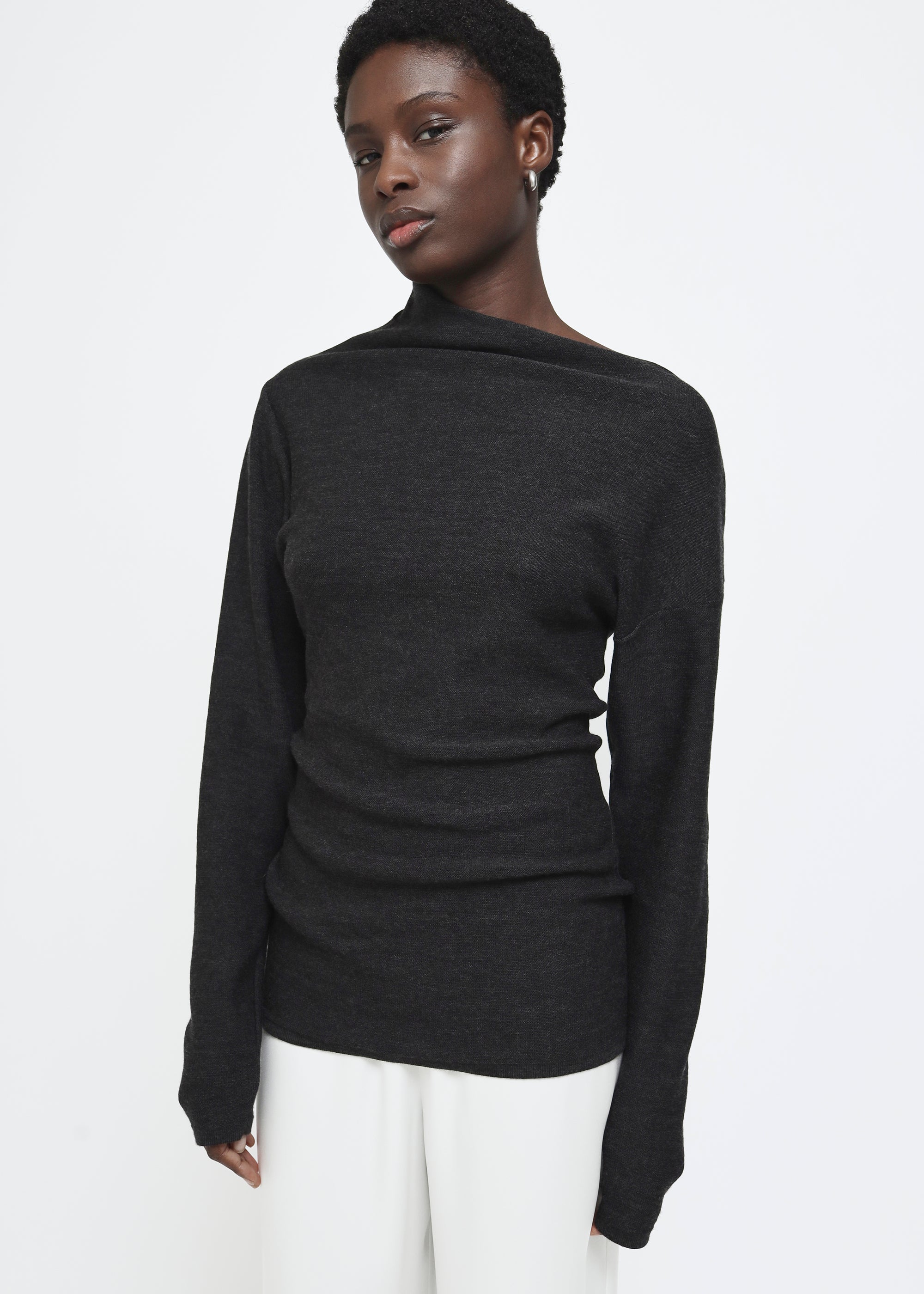 A dark gray long-sleeve knit top with a wide asymmetric neckline.