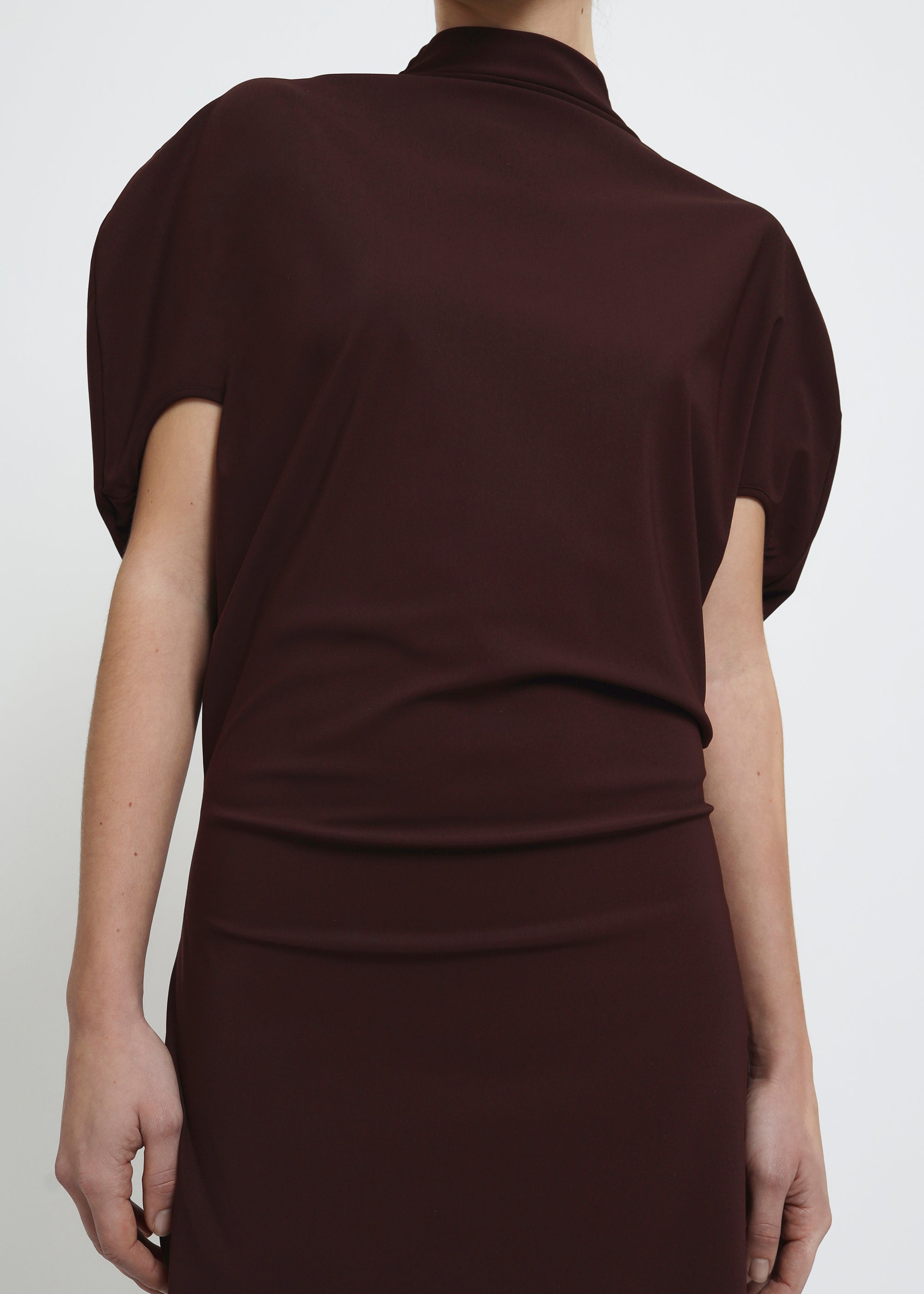 A dark brown red mock-neck dress with short puff sleeves.
