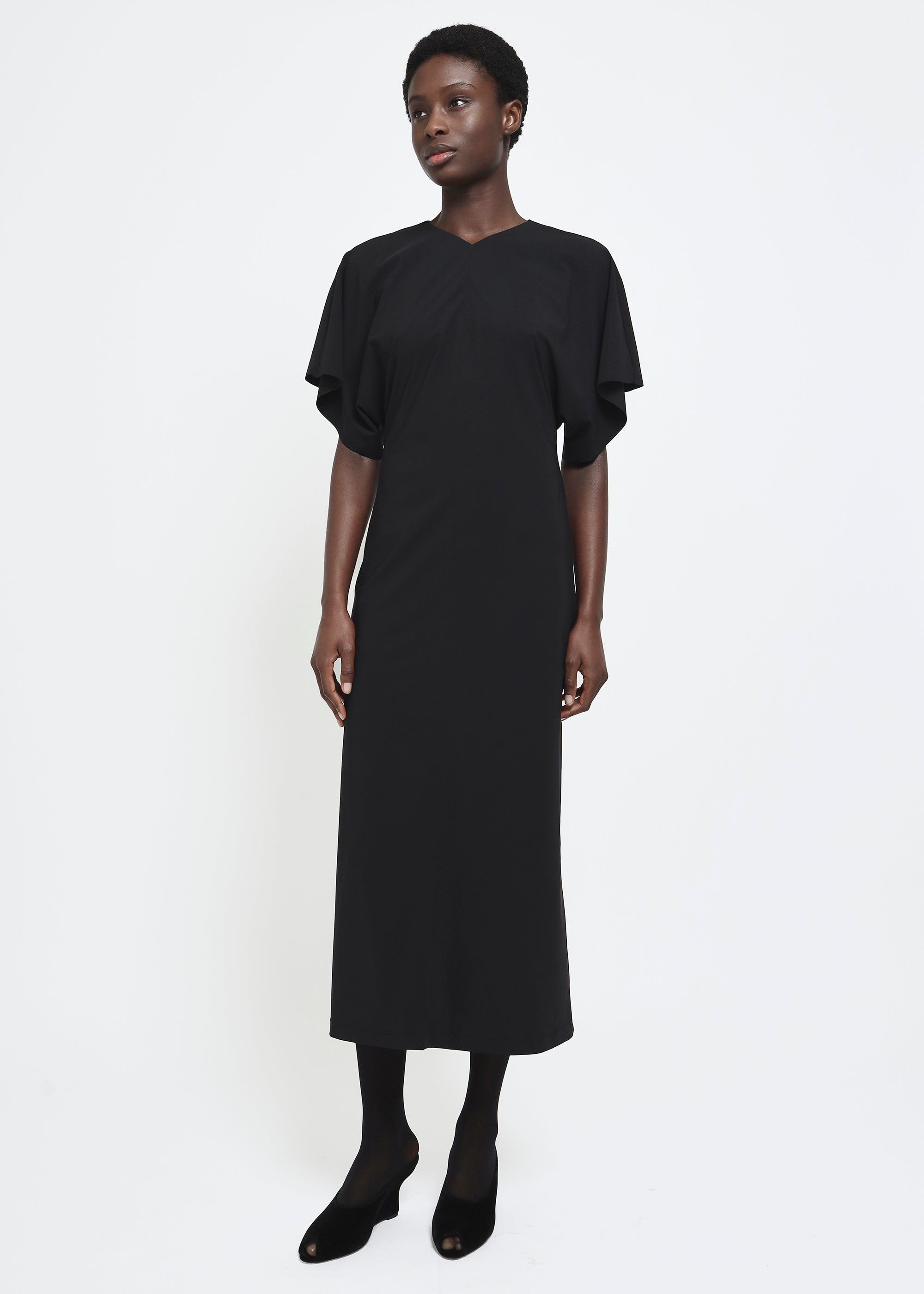 A black midi dress with short flutter sleeves.