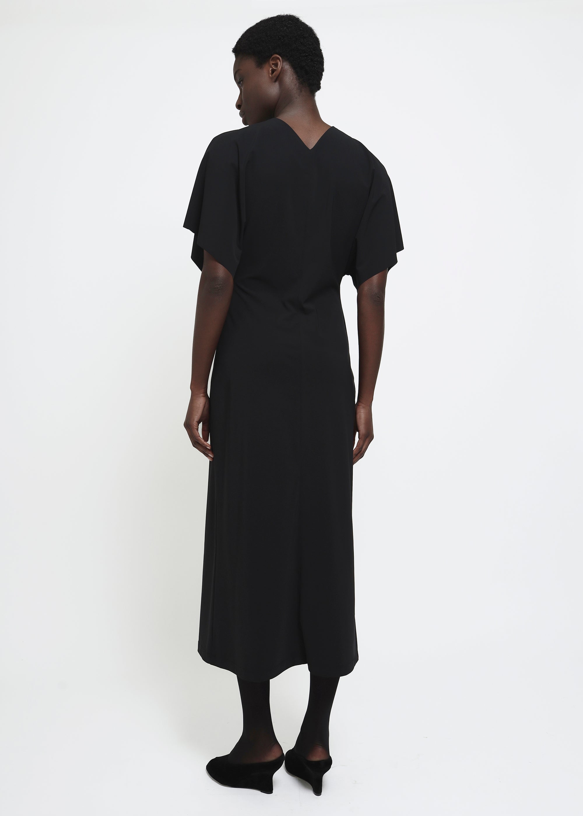 A black midi dress with short flutter sleeves.