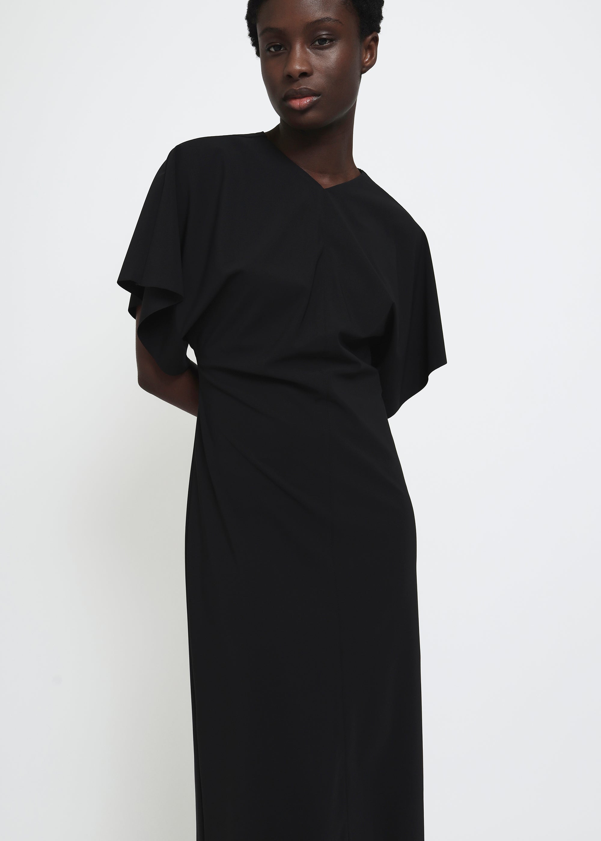 A black midi dress with short flutter sleeves.