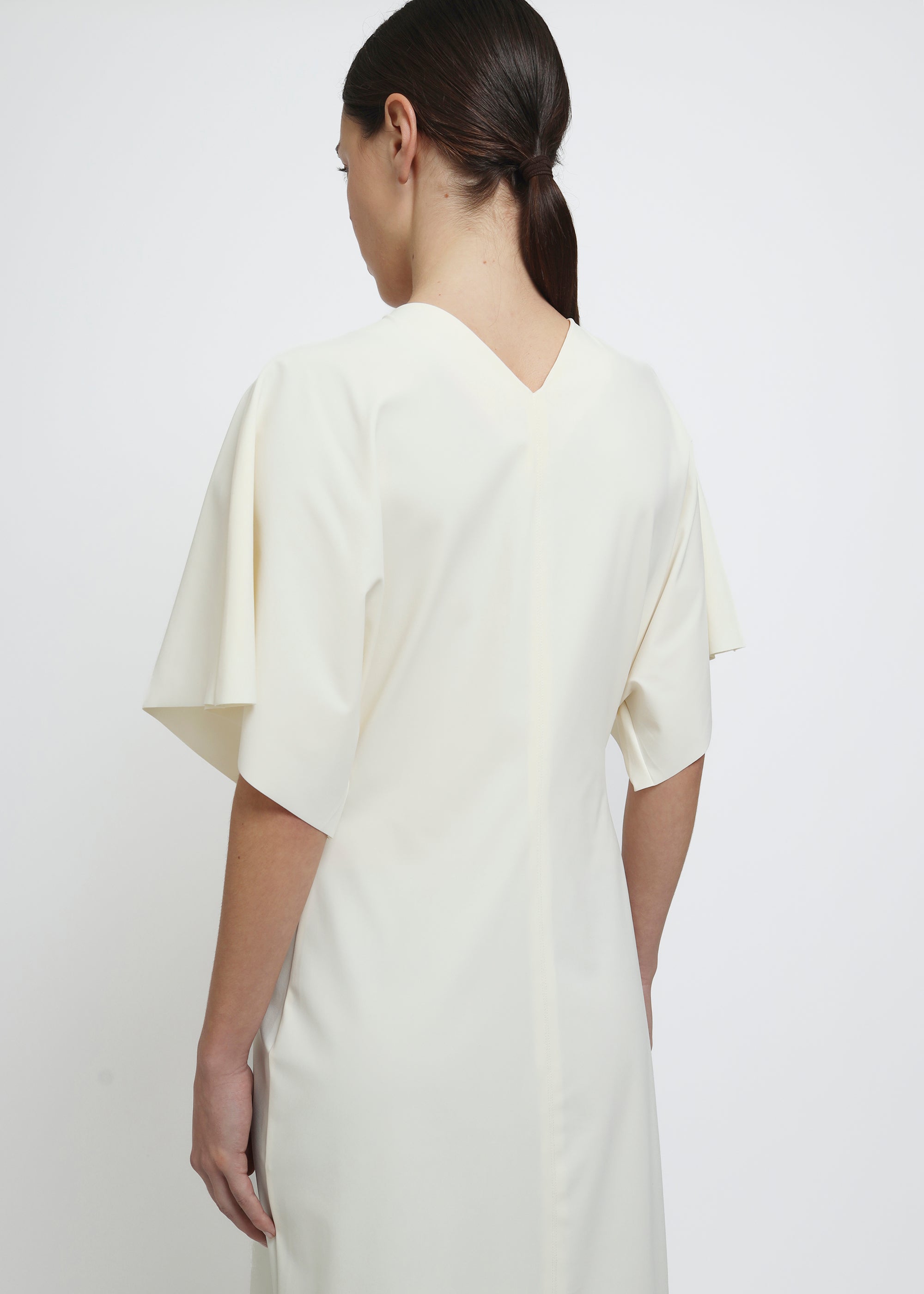 A cream-colored midi dress with short flutter sleeves.