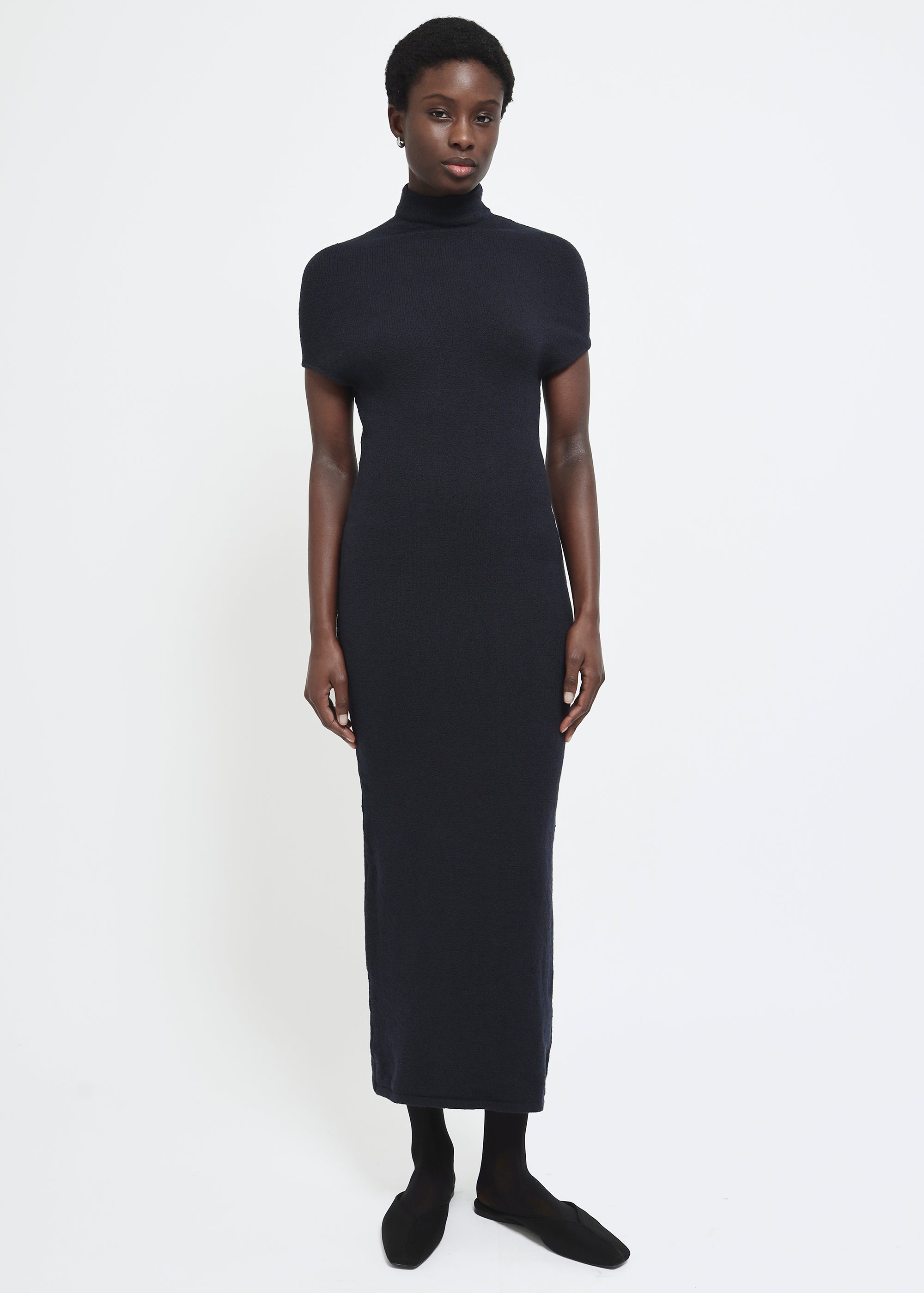 A navy cap-sleeve mock neck midi dress in a textured yarn.