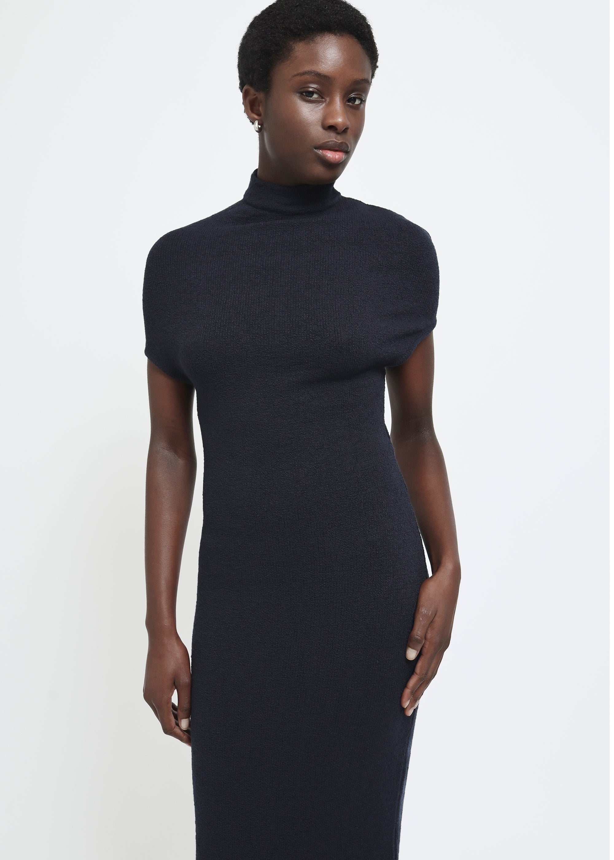 A navy cap-sleeve mock neck midi dress in a textured yarn.