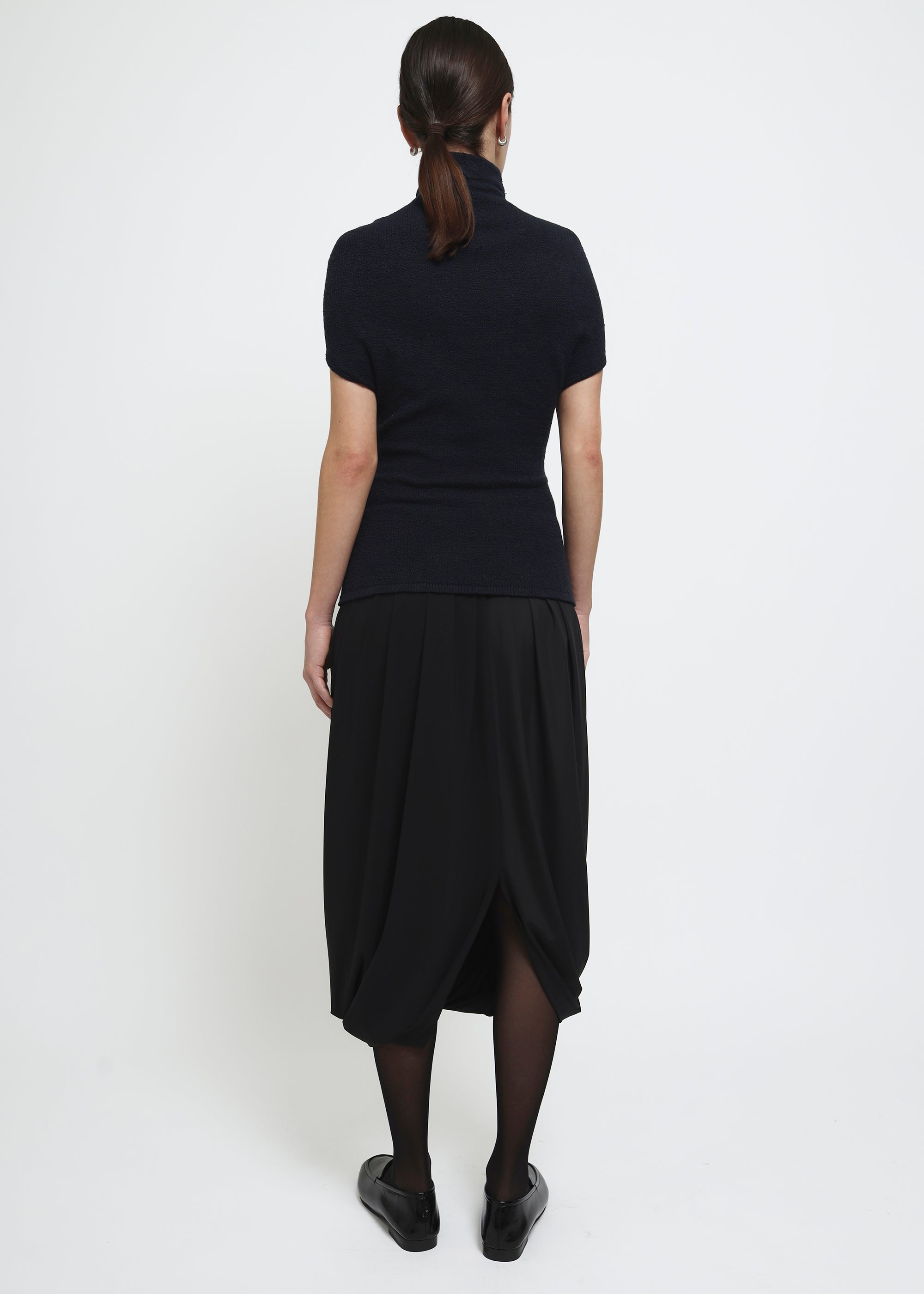 A navy cap-sleeve mock neck top in a textured bouclé like yarn.