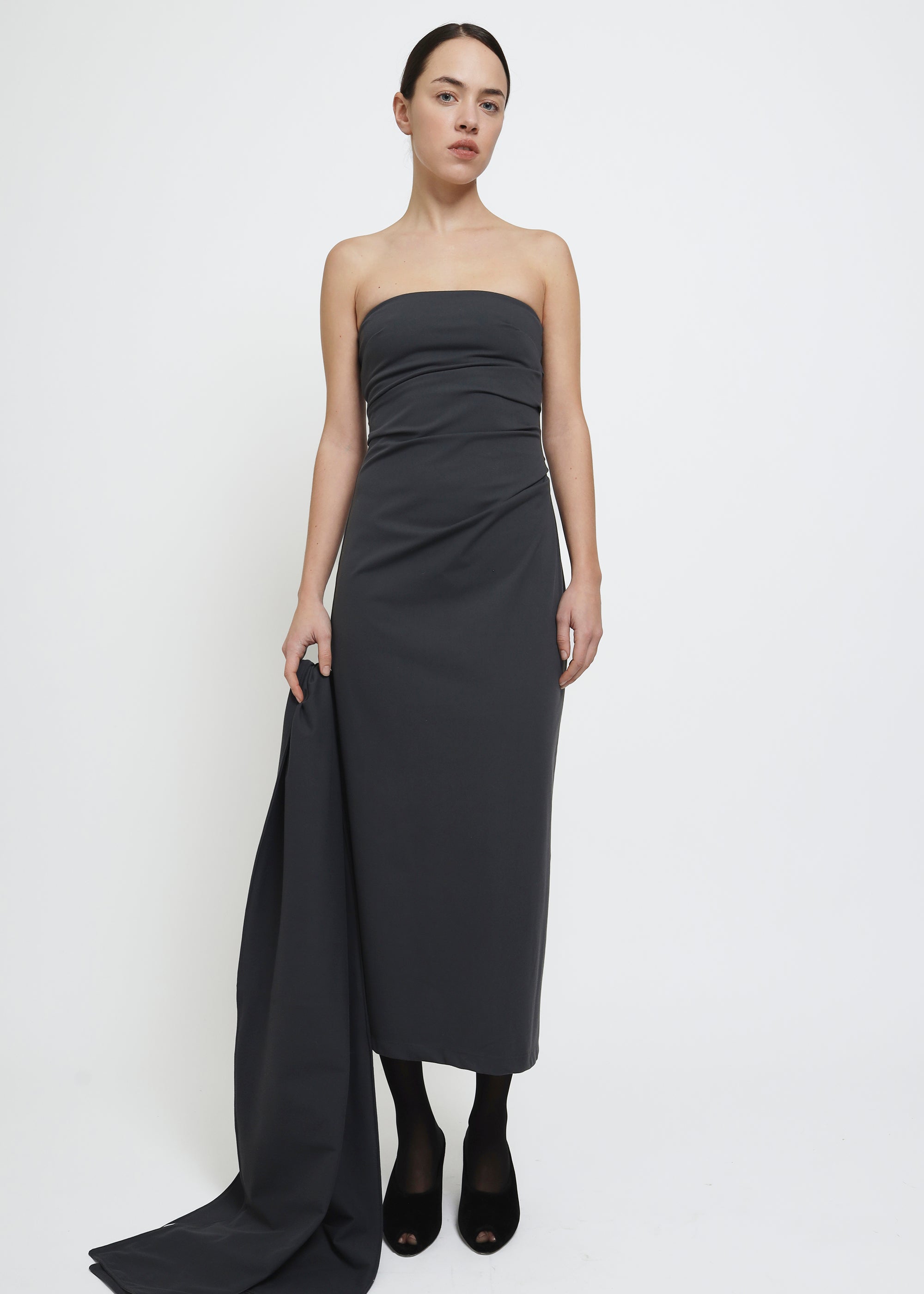 A dark gray strapless midi dress with a draped bodice.
