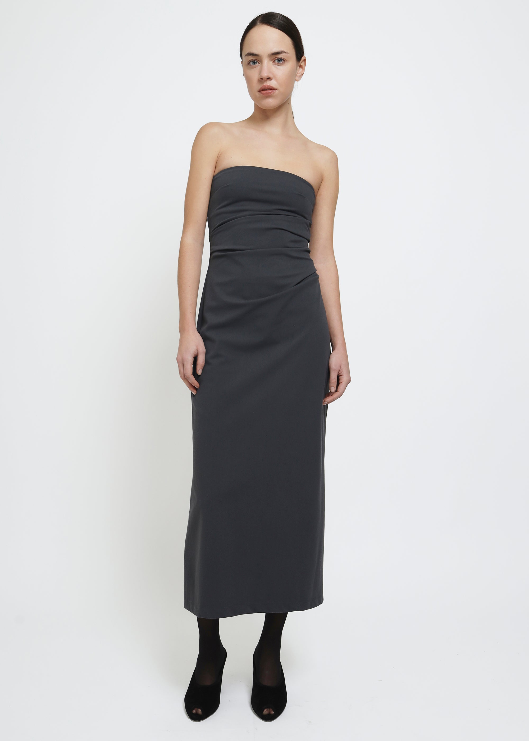 A dark gray strapless midi dress with a draped bodice.