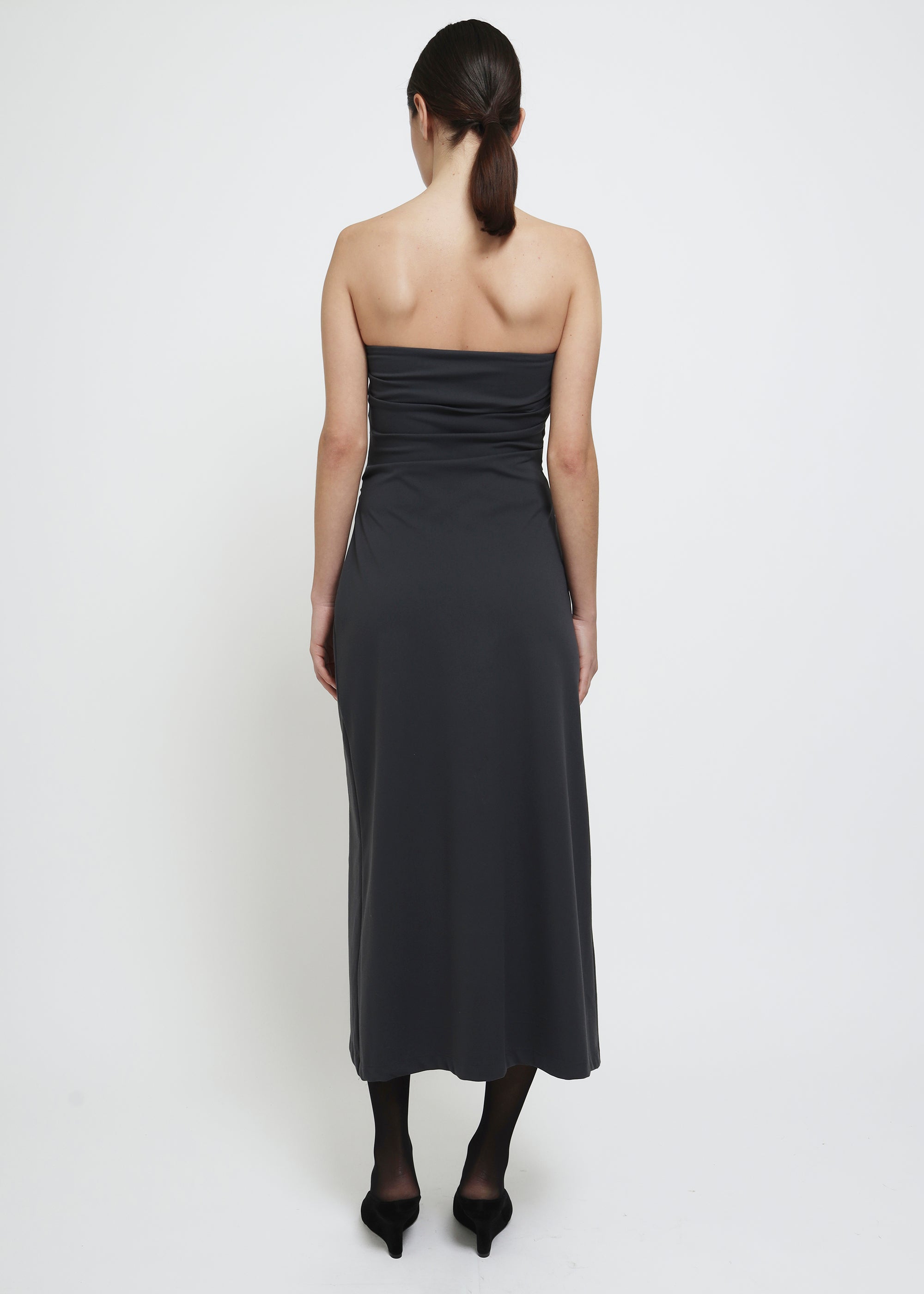 A dark gray strapless midi dress with a draped bodice.