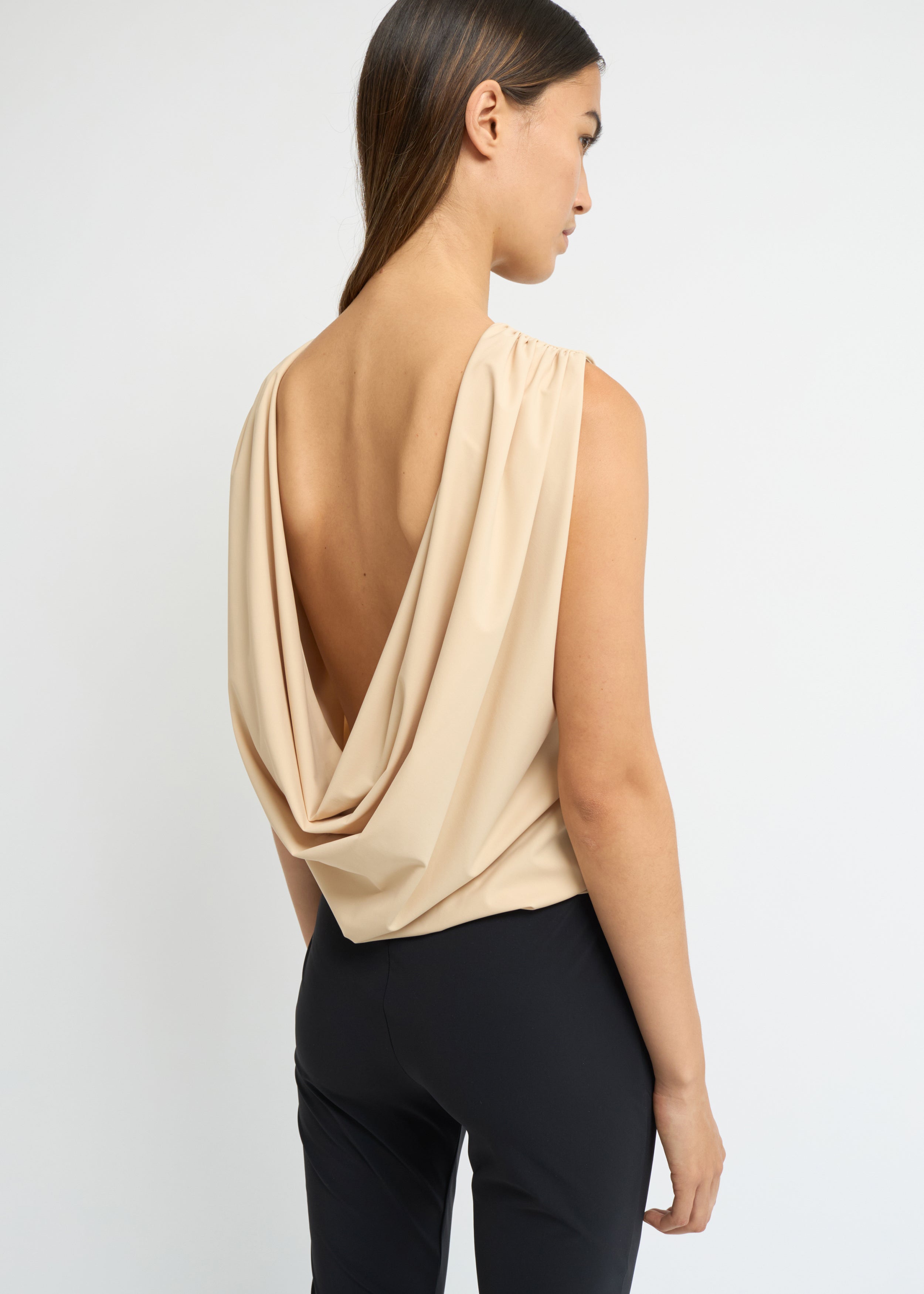 Sand sleeveless top with a high neckline and open back