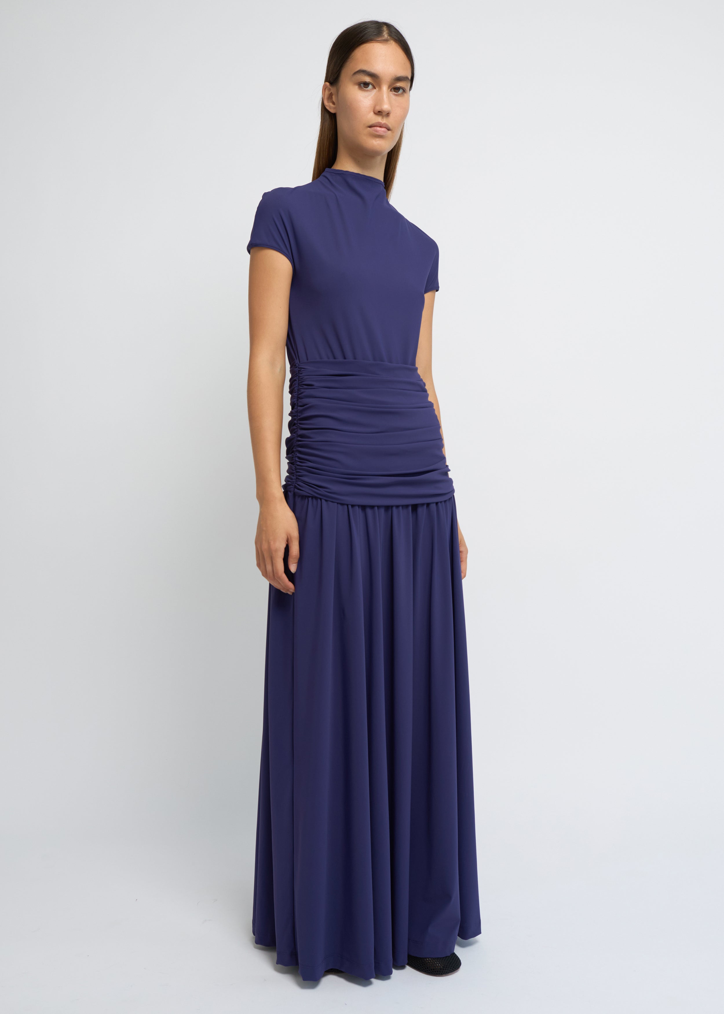 Violet ankle-length dress with cap sleeves, high neckline and softly gathered waist