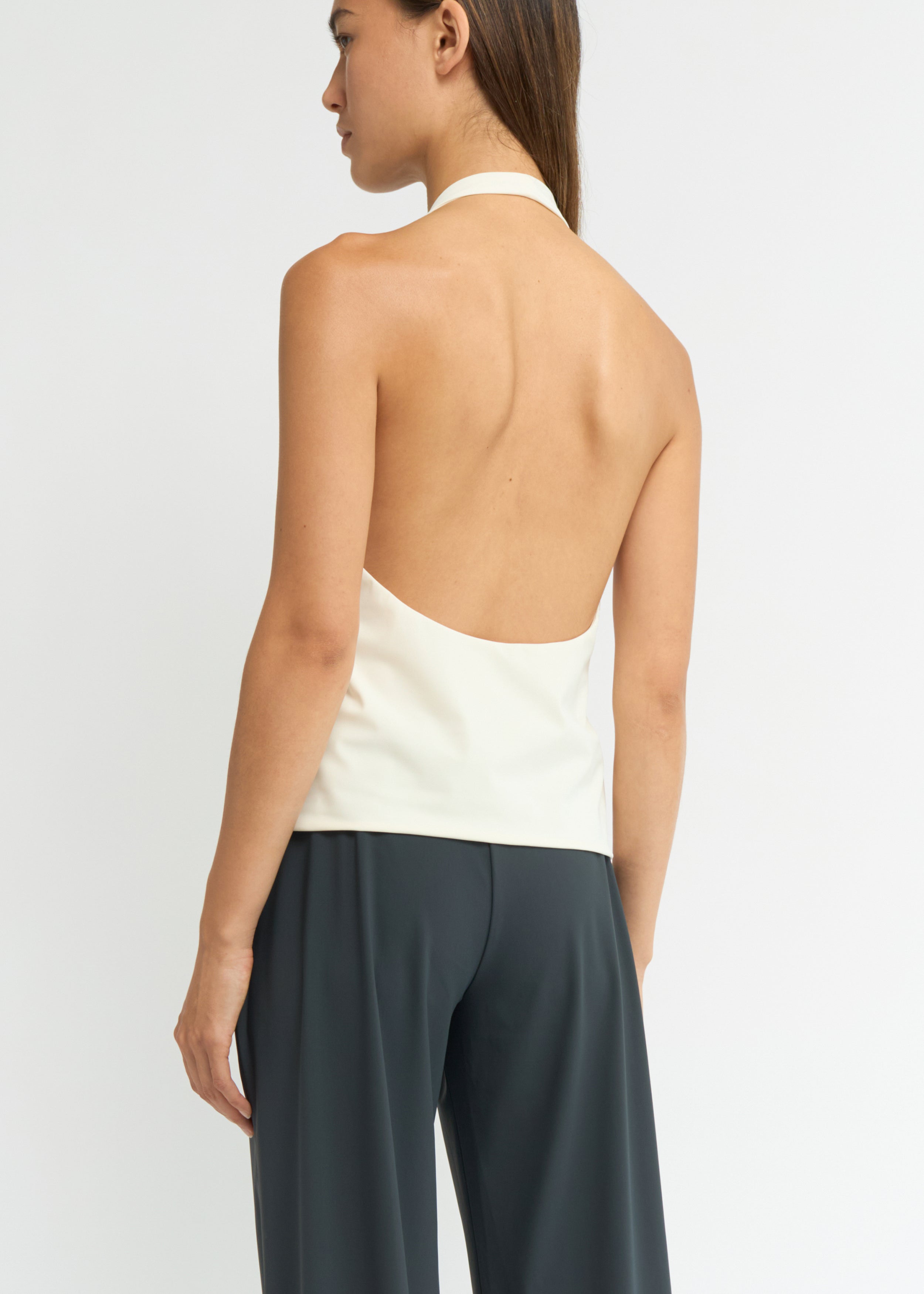 Cream halter neck top with a deep scoop neckline and open back