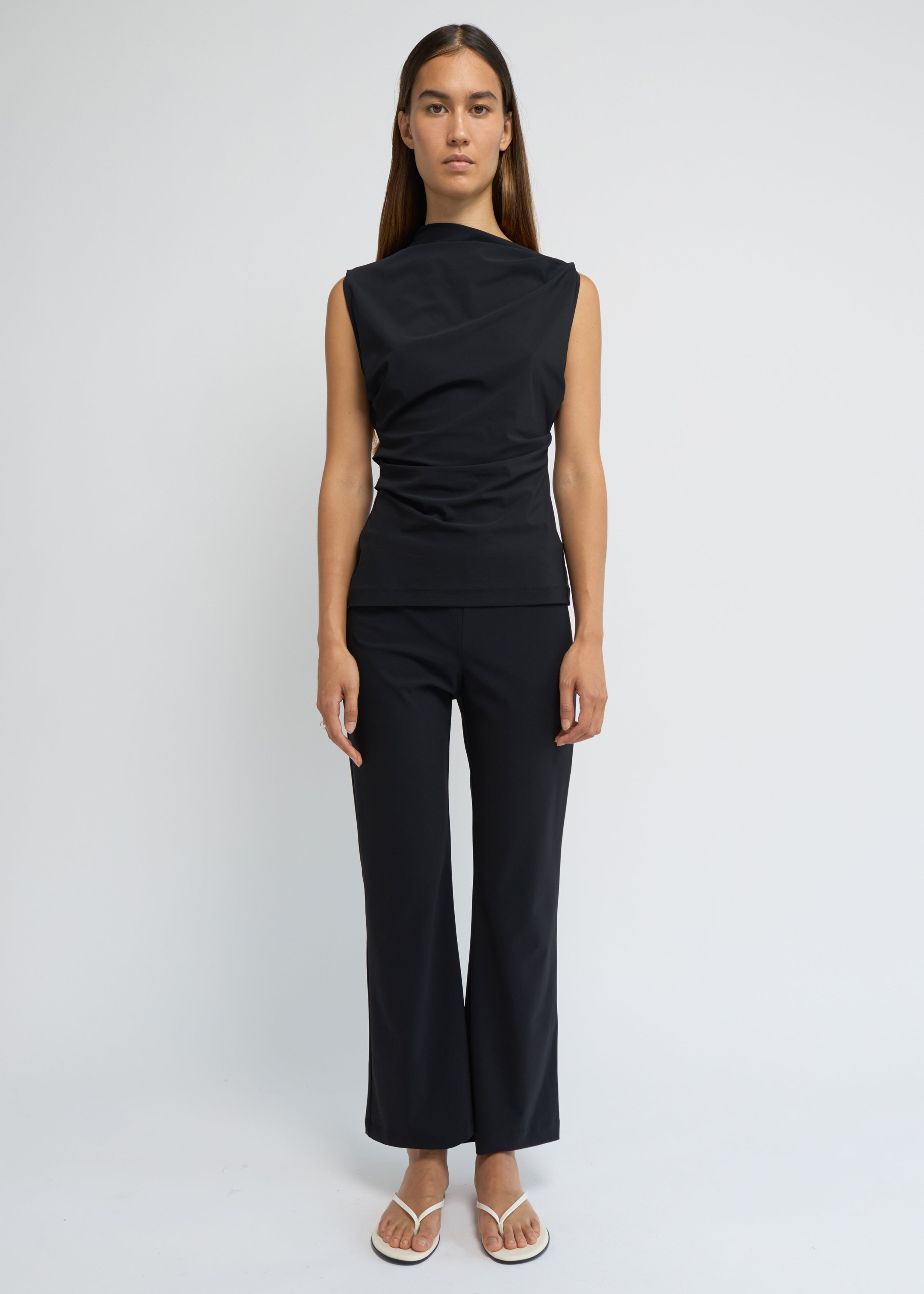 Black cropped kick-flare pants with a subtle flare at the hem