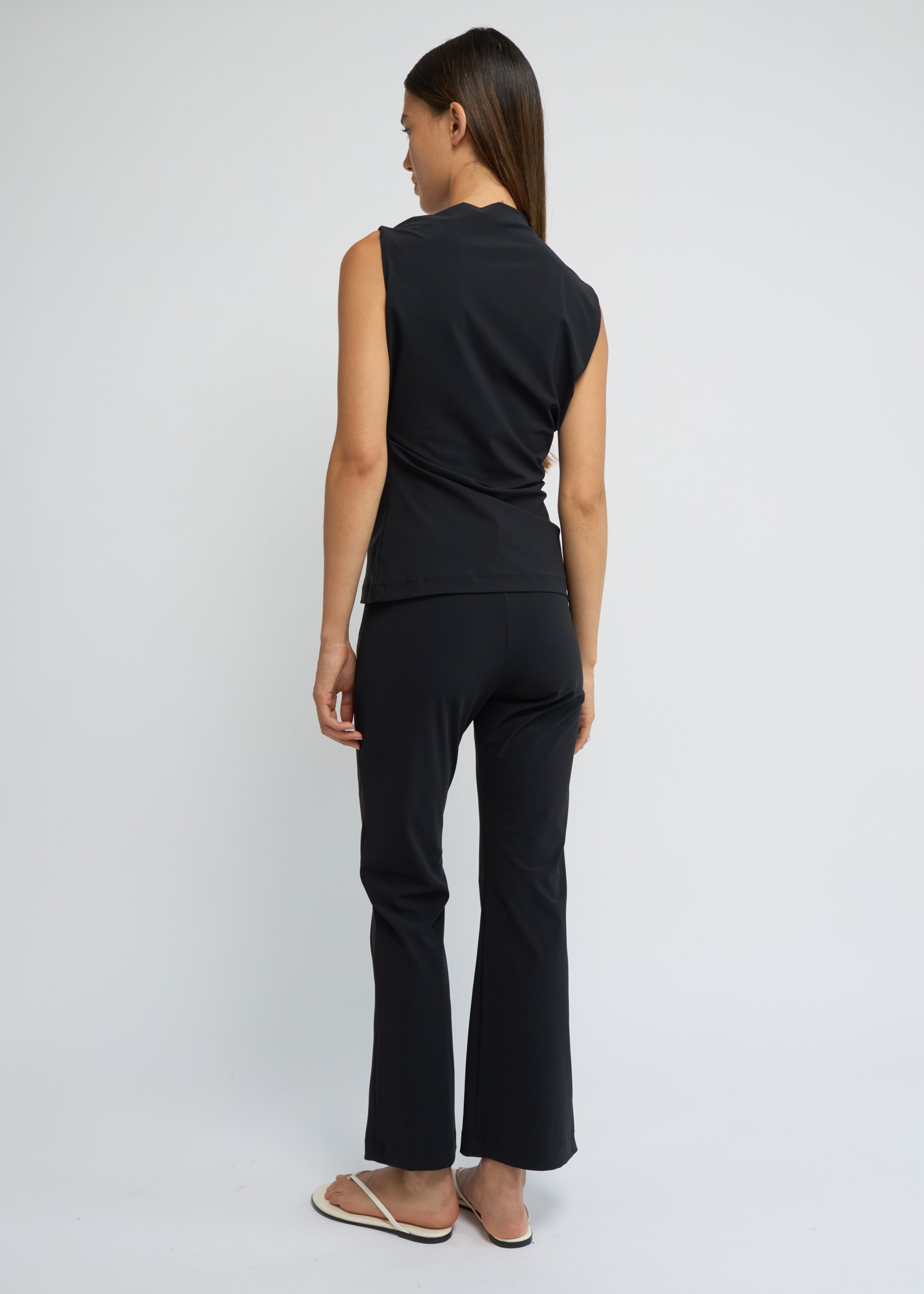 Black cropped kick-flare pants with a subtle flare at the hem