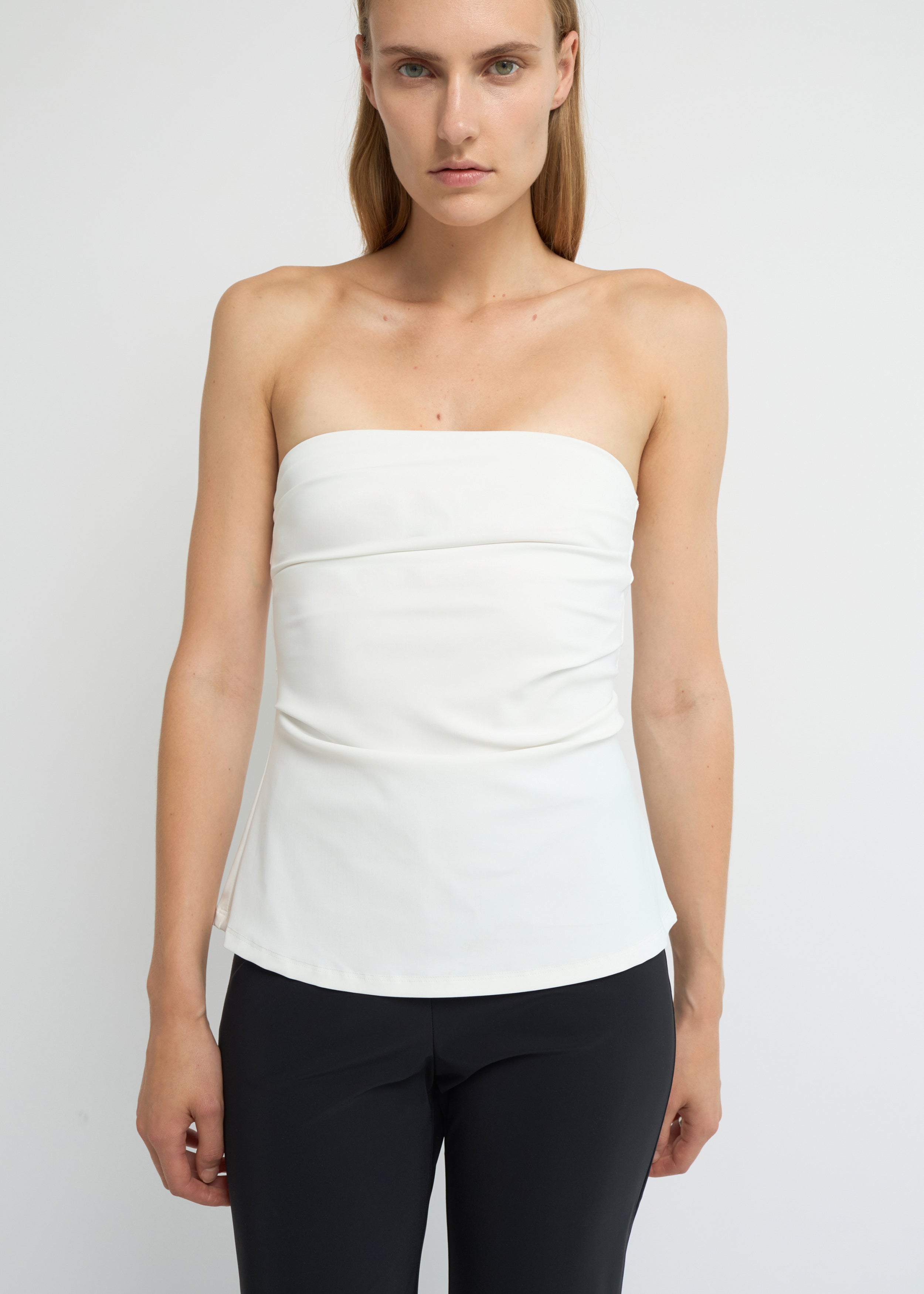 Off-white strapless top with a soft A-line shape and clean neckline